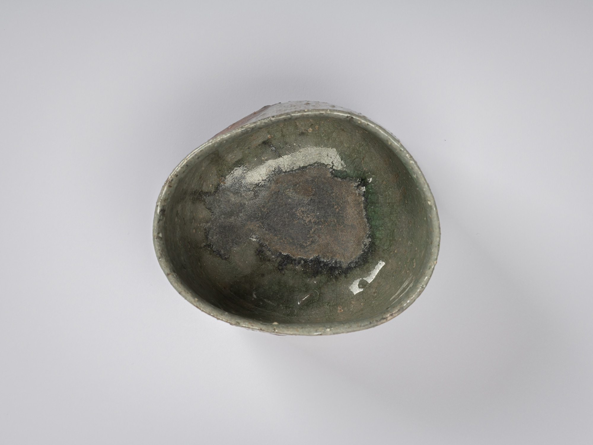 Overhead view of Shigaraki Tsu Tsu Chawan. The interior is coated in glossy green-gray glaze with...