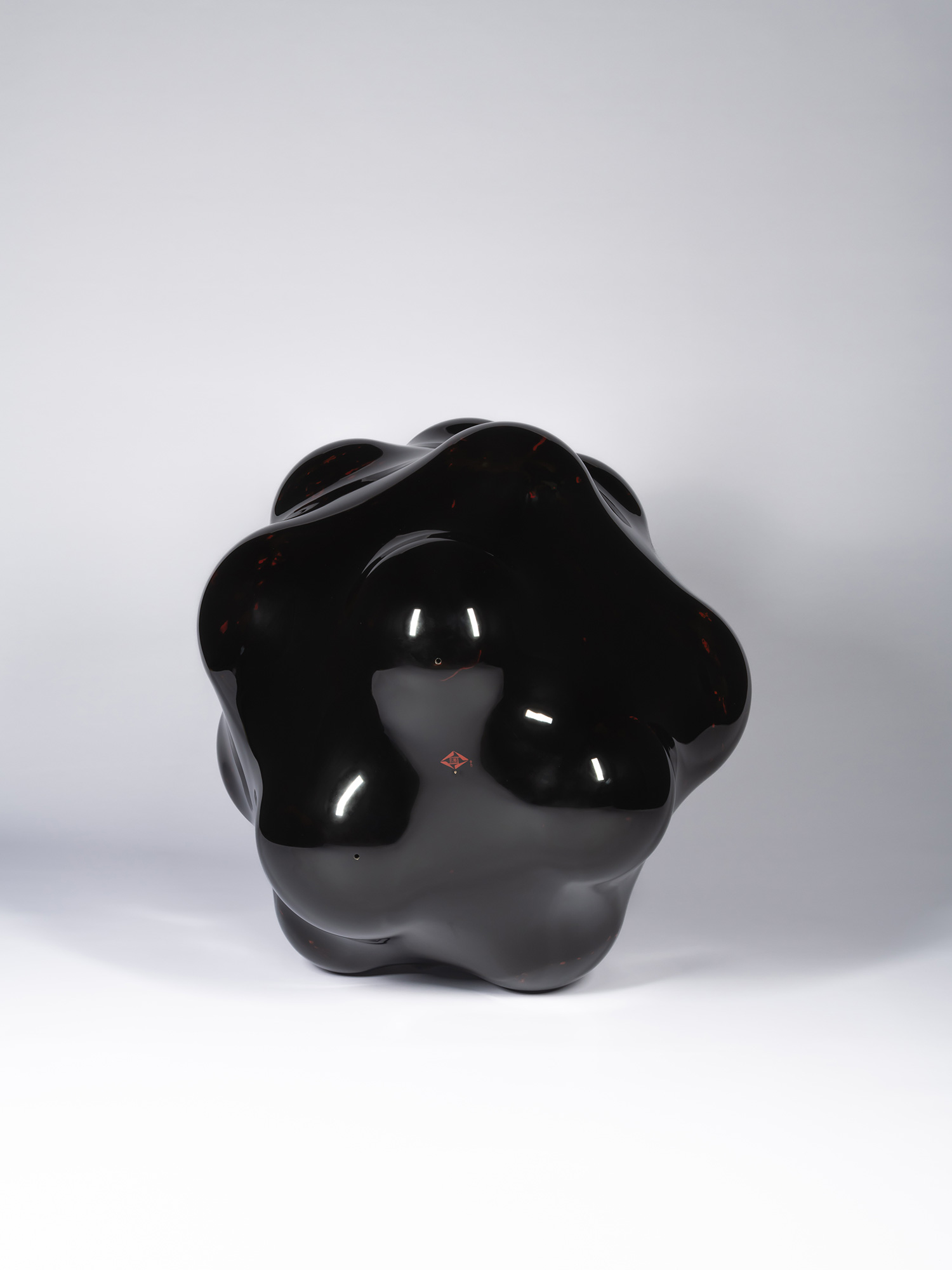 Bottom view of Surface Tactility #22 showing the sculpture resting on multiple rounded contact...