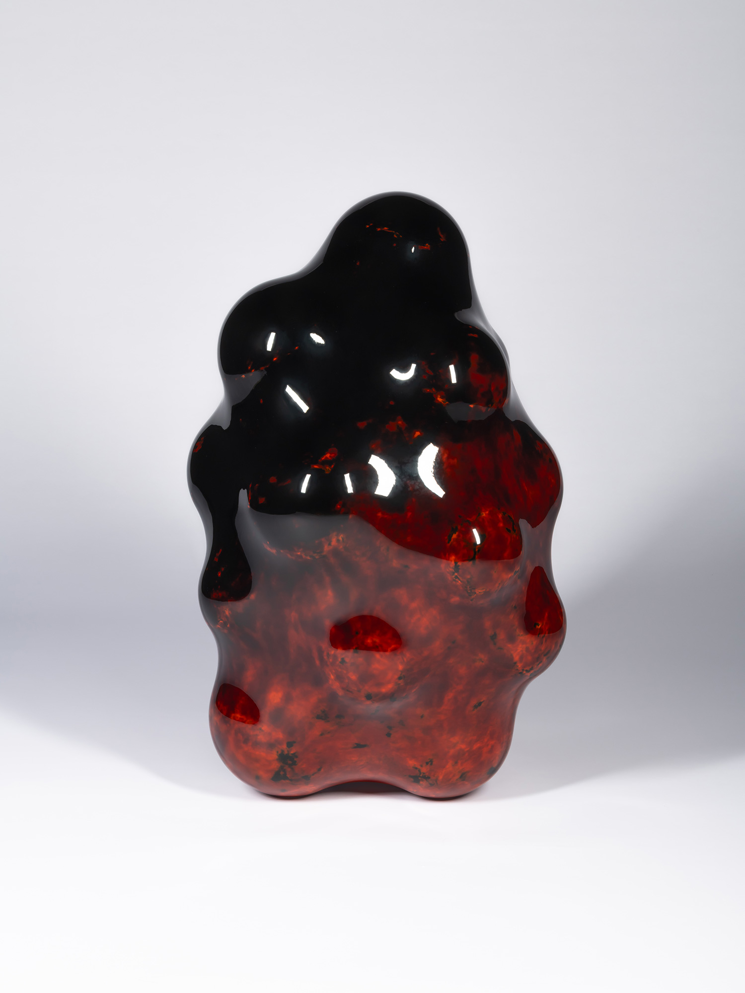 View of Surface Tactility #32 showing a vertical biomorphic form with a glossy black upper section...