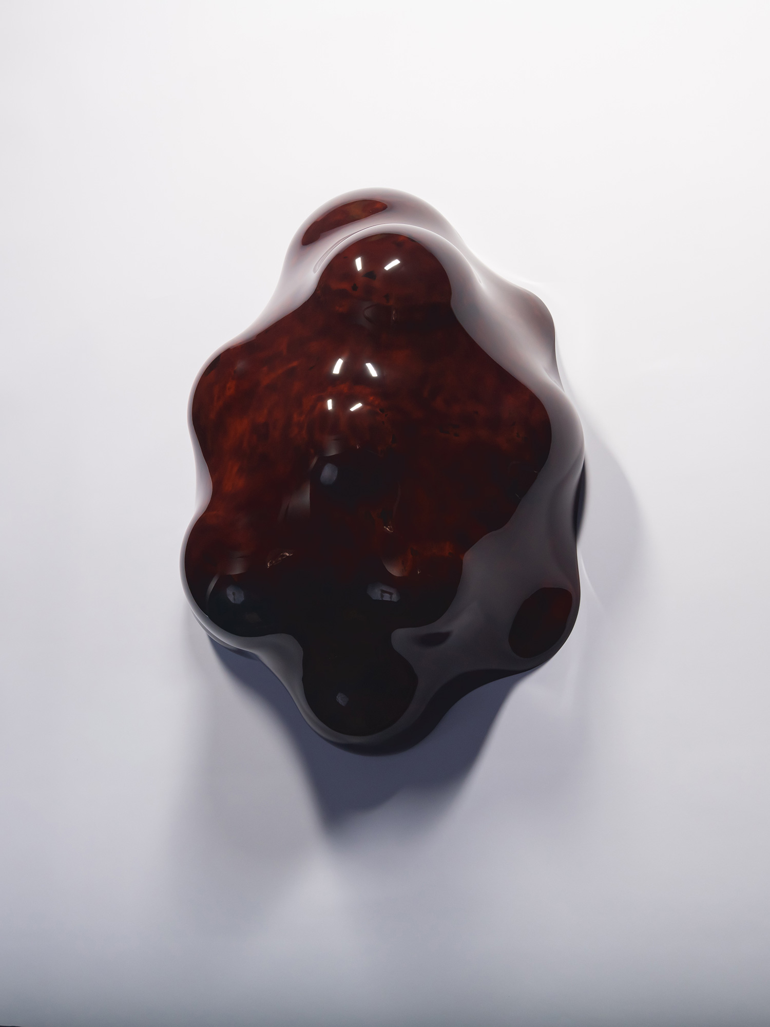 Front view of Surface Tactility (on wall) #1 mounted on a white wall. The lacquer sculpture has...