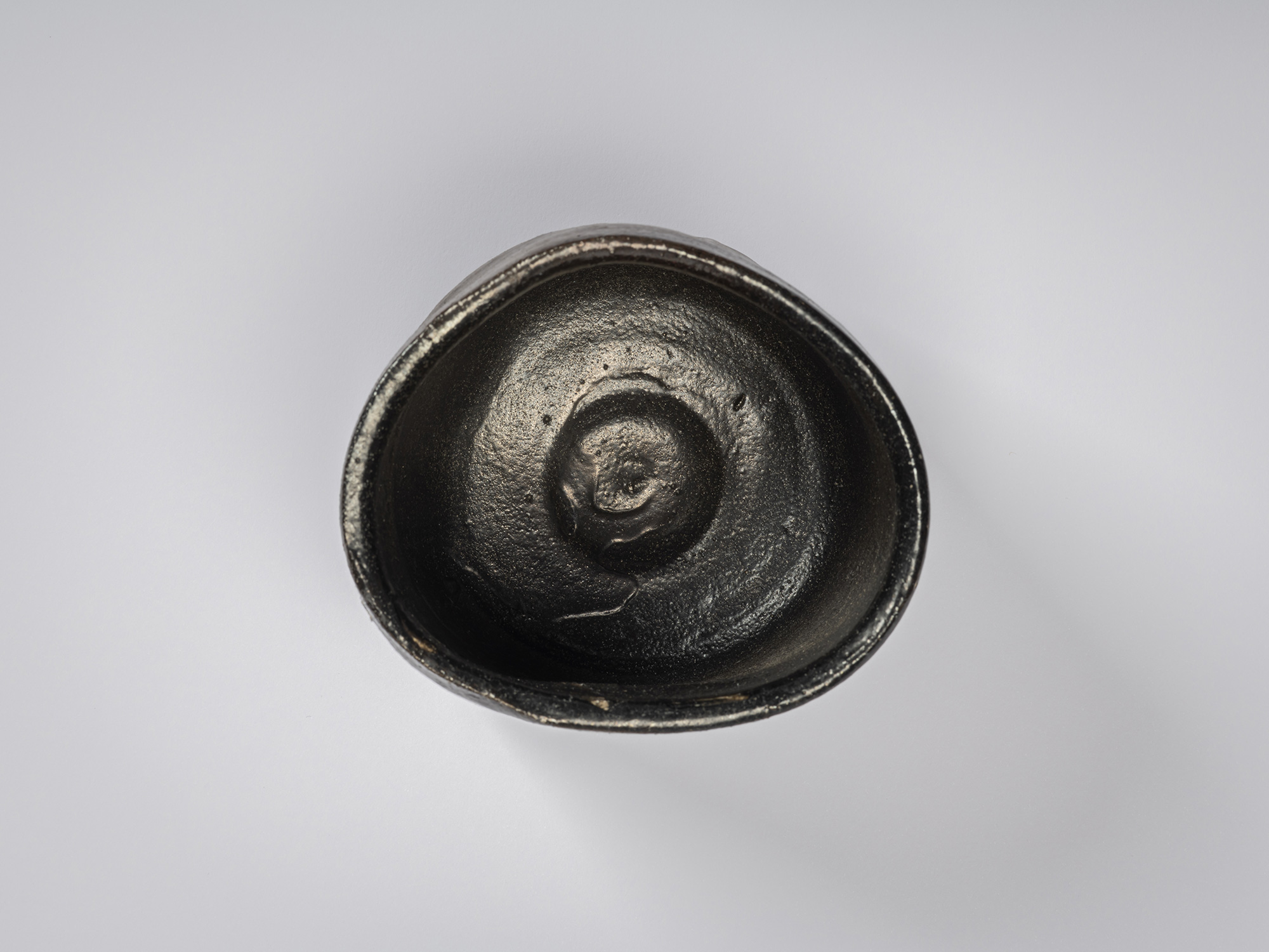 Overhead view of a hikidashi-type tea bowl by Shiro Tsujimura. The interior is coated in a glossy...