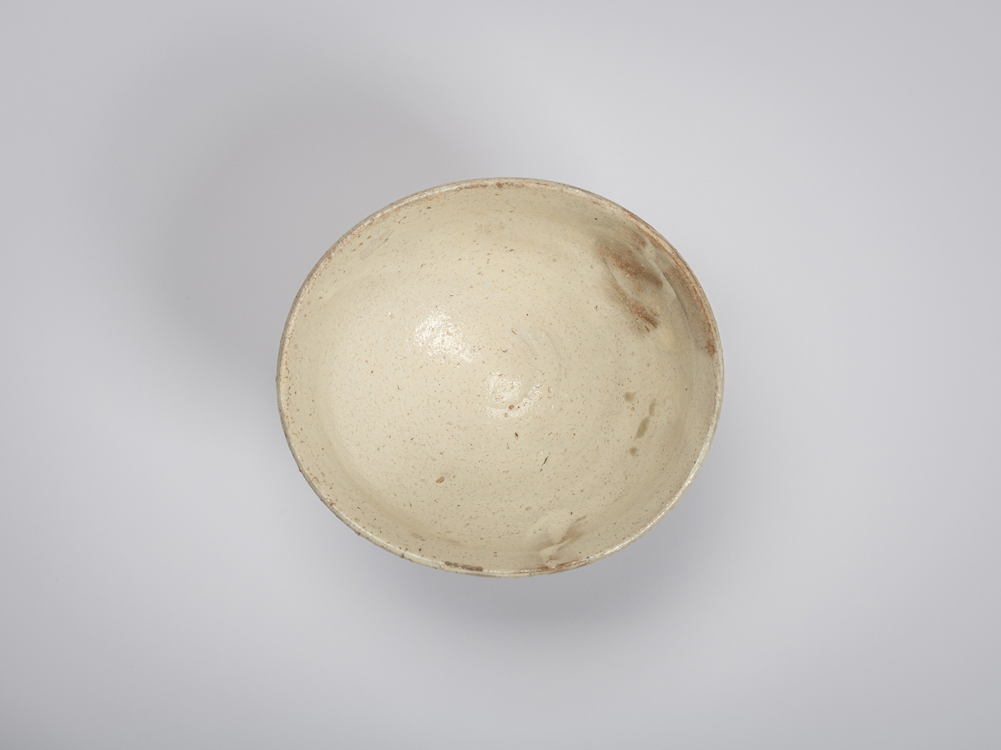 Overhead view of the interior of Tea Bowl (Tripodal Foot) by Shiro Tsujimura. The bowl is coated...