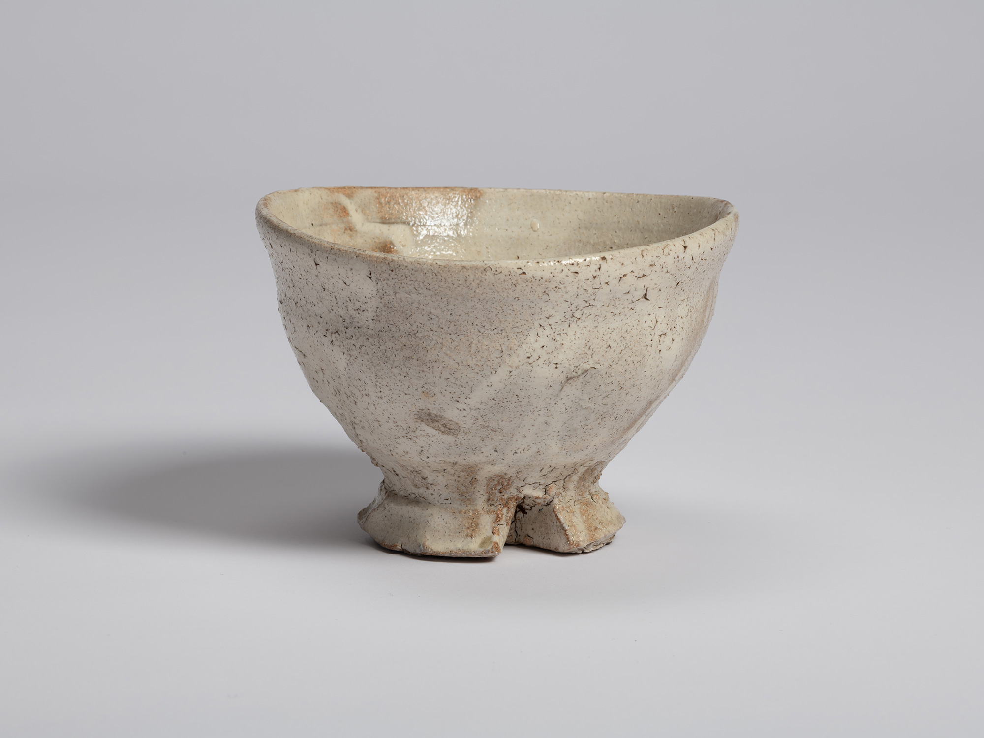 Tea Bowl (Tripodal Foot) by Shiro Tsujimura. Hand-formed tea bowl with a softly flared rim and...