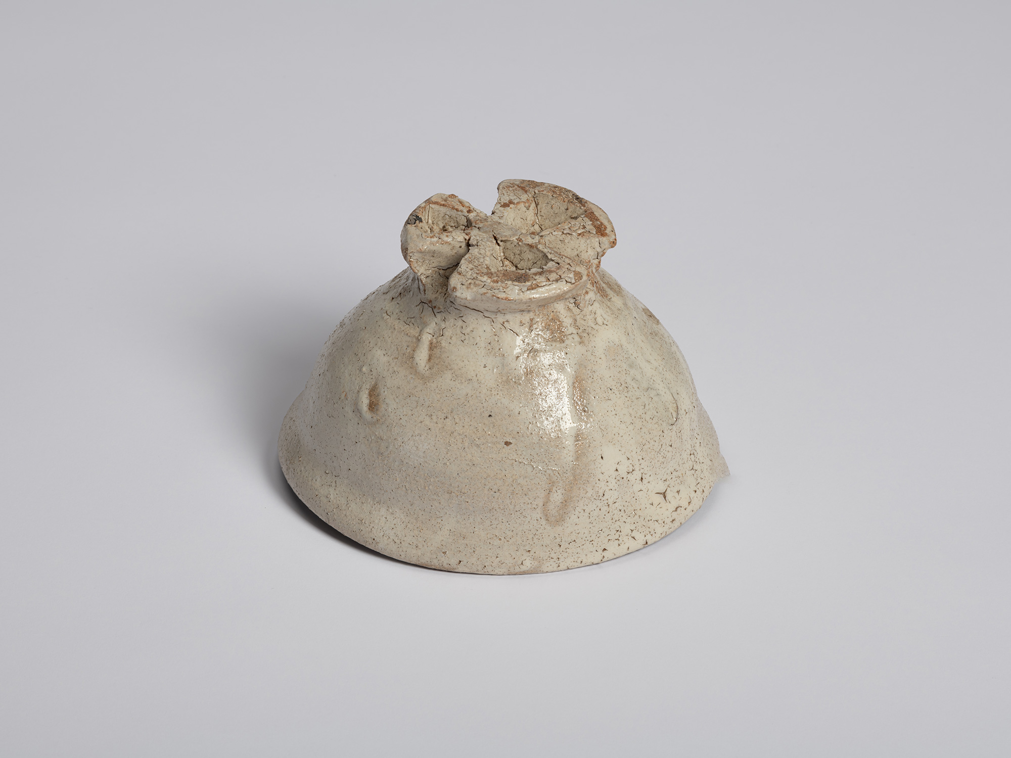 Low-angle view of the underside of Tea Bowl (Tripodal Foot) by Shiro Tsujimura. The three sculptural...
