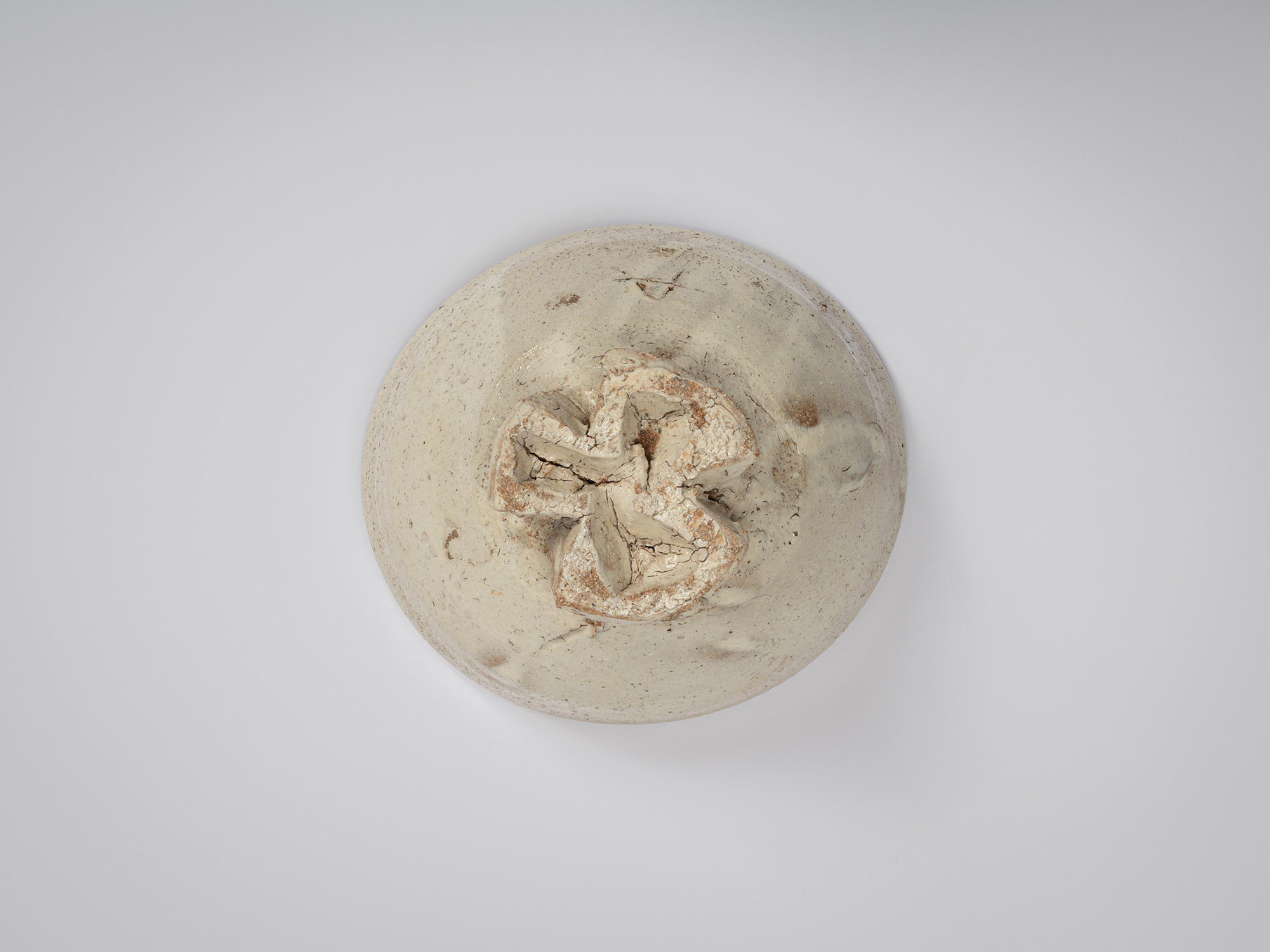 Overhead view of the underside of the tea bowl showing the full configuration of the tripodal foot....