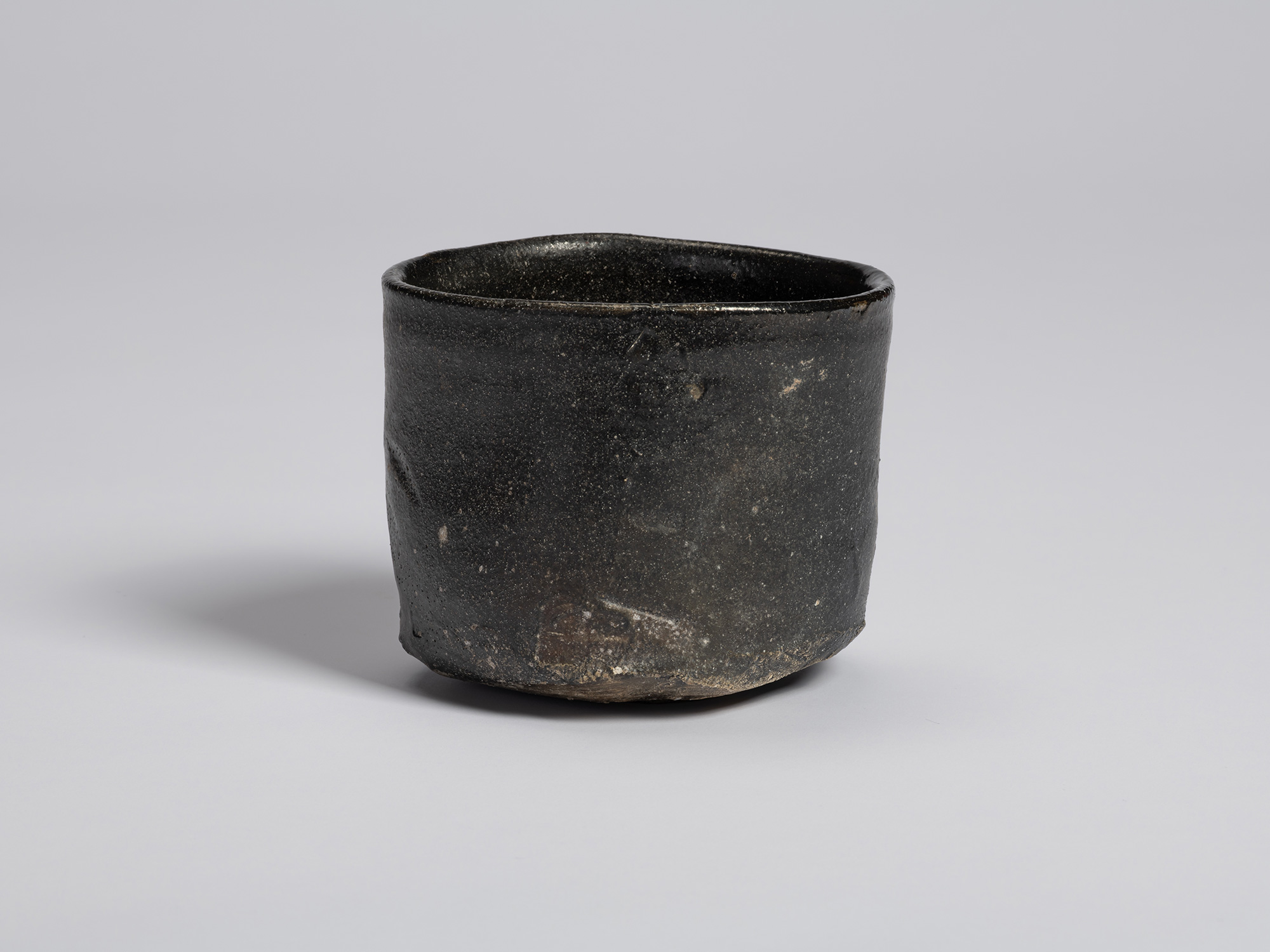 Hikidashi-style tea bowl by Shiro Tsujimura. The form is nearly cylindrical with a gently undulating...