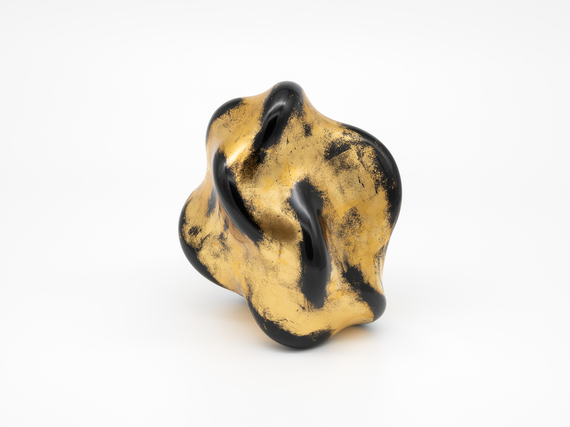 Front view of Untitled (Faded Gold). Two elongated openings curve through the surface, framed by...
