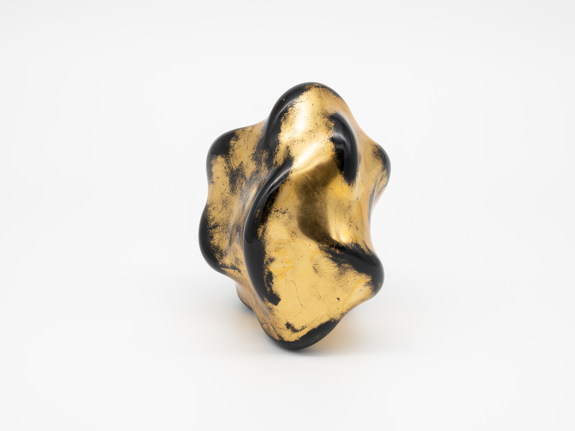 Alternate angle of Untitled (Faded Gold) showing a deep central fold framed by sweeping, curved...
