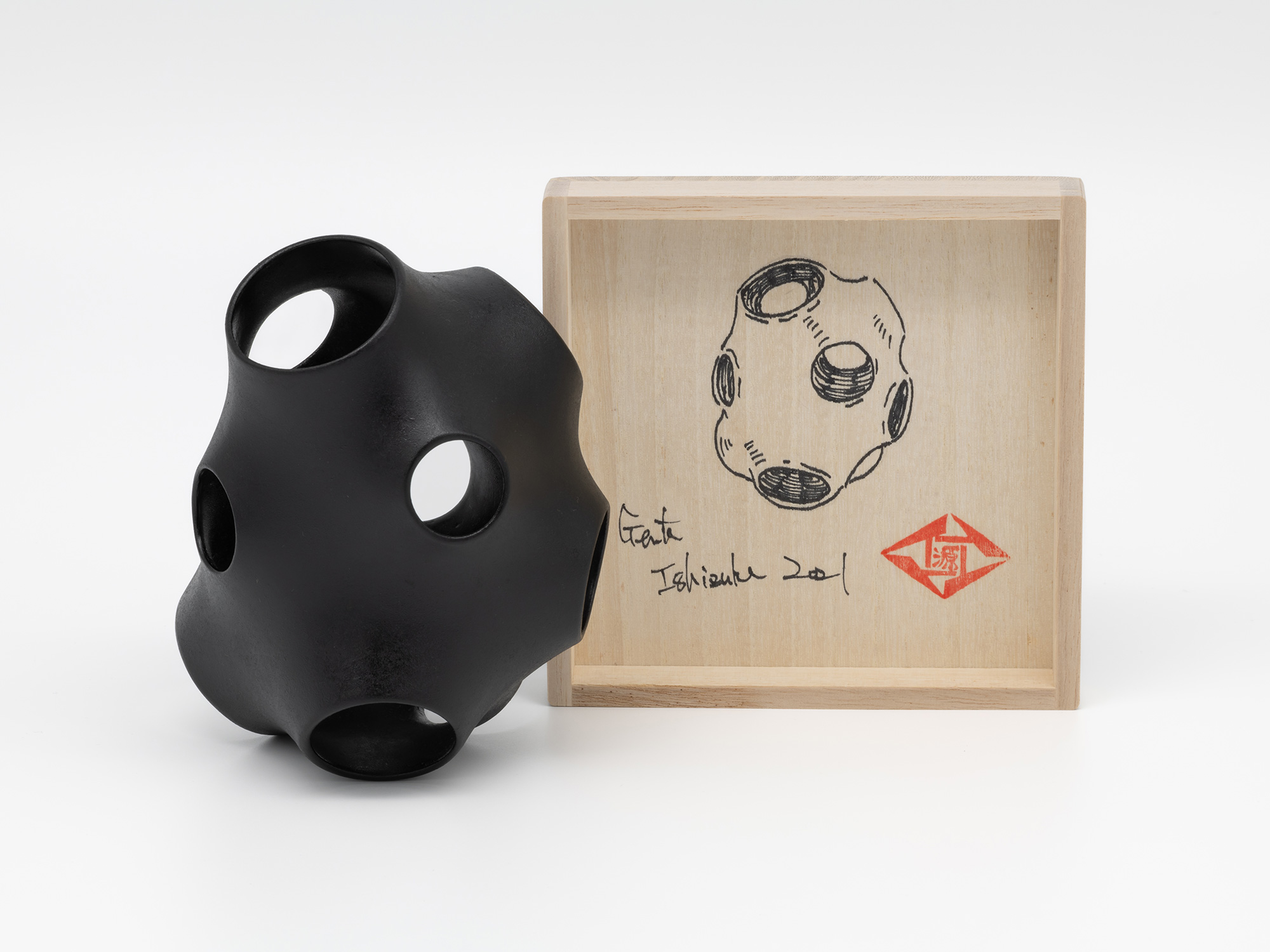 Absence – Holes by Genta Ishizuka displayed beside its open paulownia wood presentation box (tomobako)....