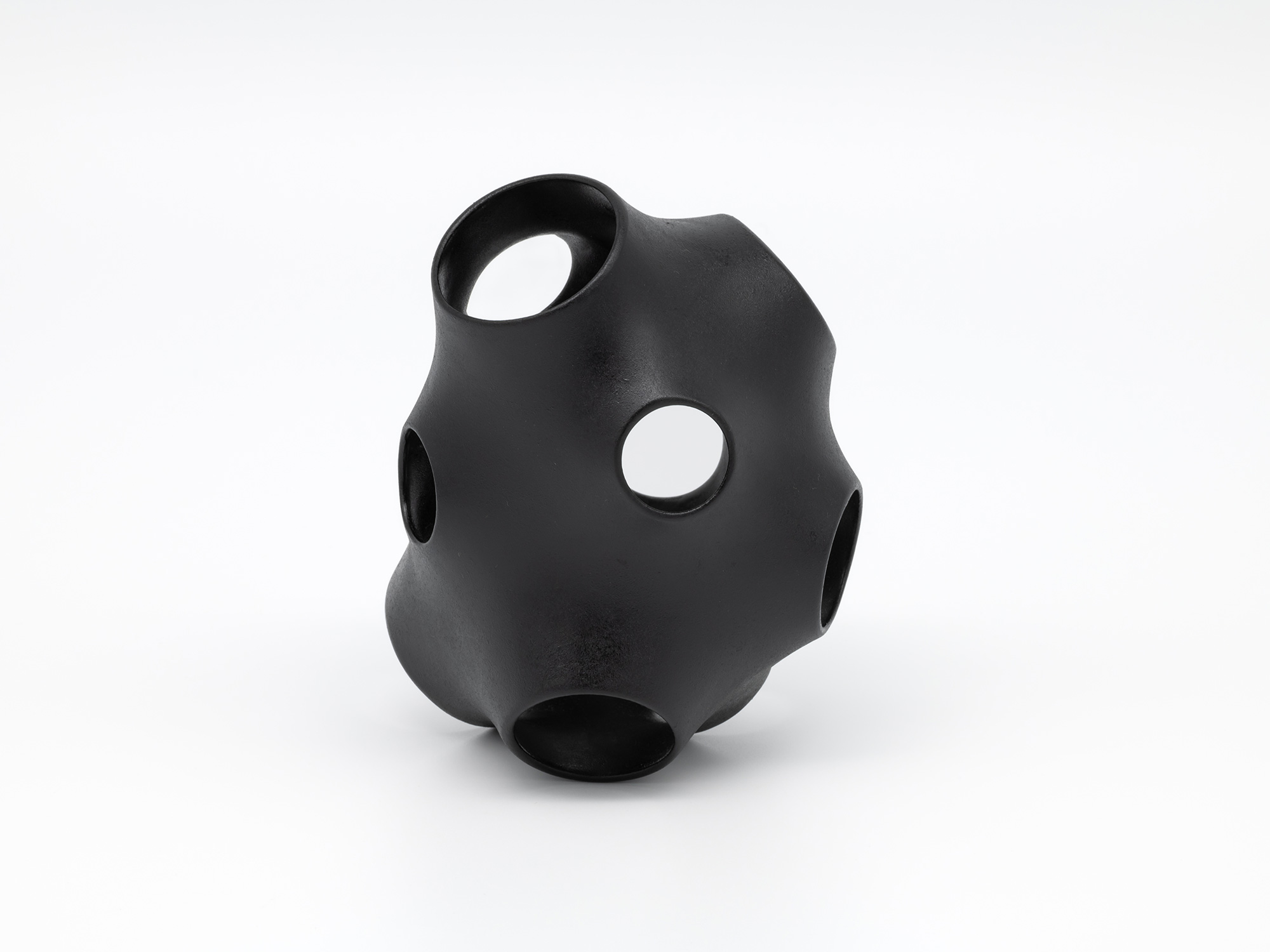 View of Absence – Holes by Genta Ishizuka, an organic black lacquer sculpture with a smooth matte...