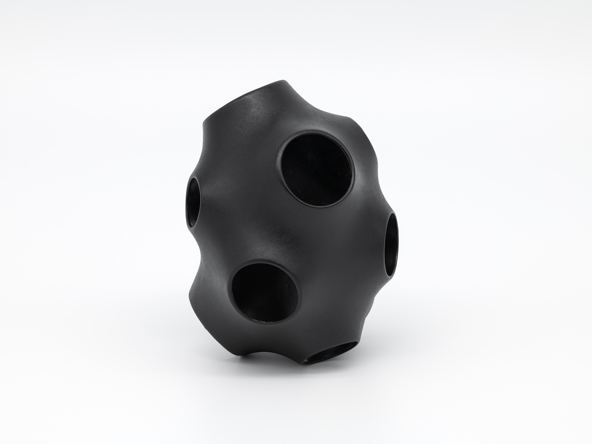 View of Absence – Holes by Genta Ishizuka, an organic black lacquer sculpture with a smooth matte...