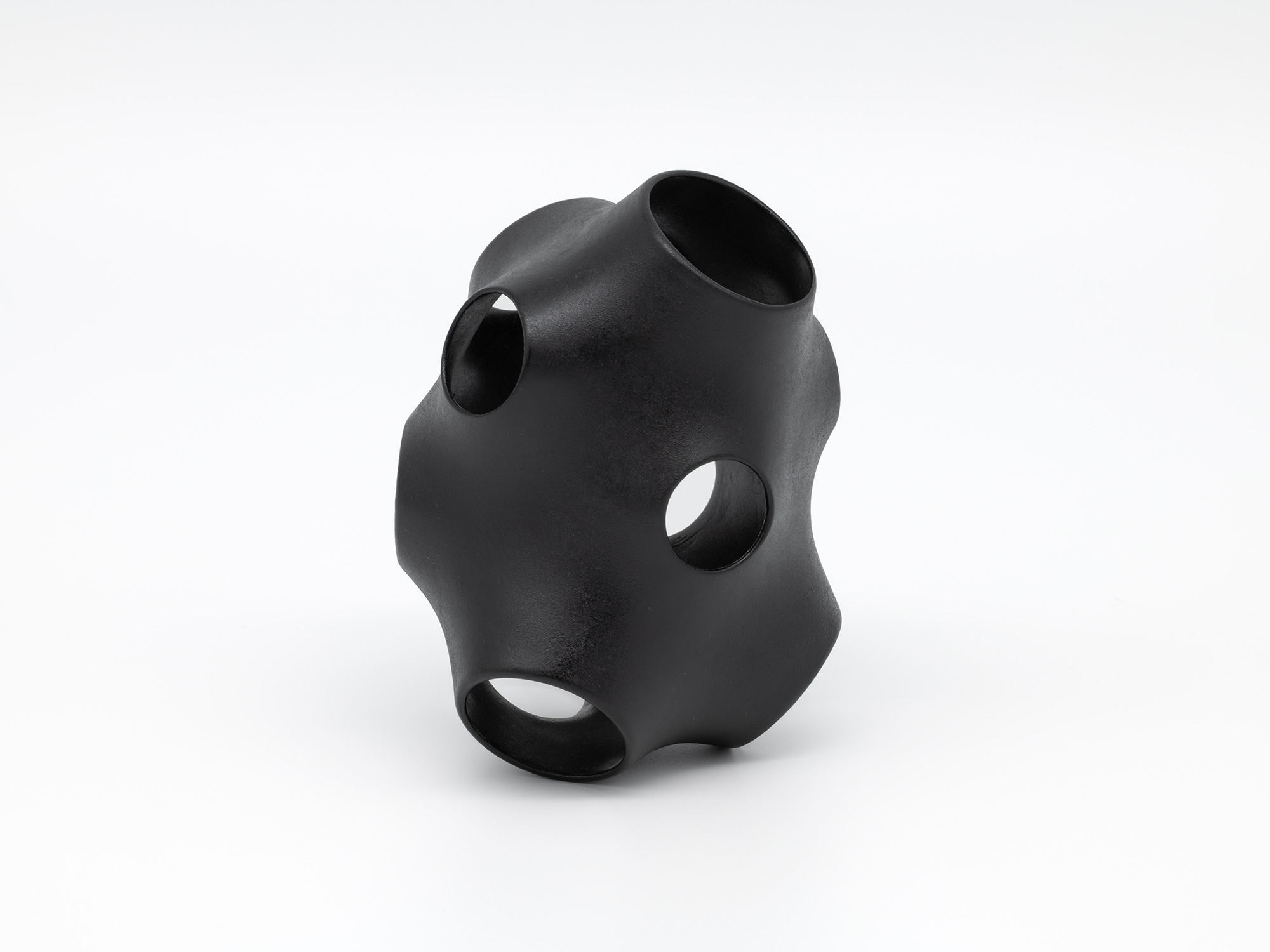 View of Absence – Holes by Genta Ishizuka, an organic black lacquer sculpture with a smooth matte...