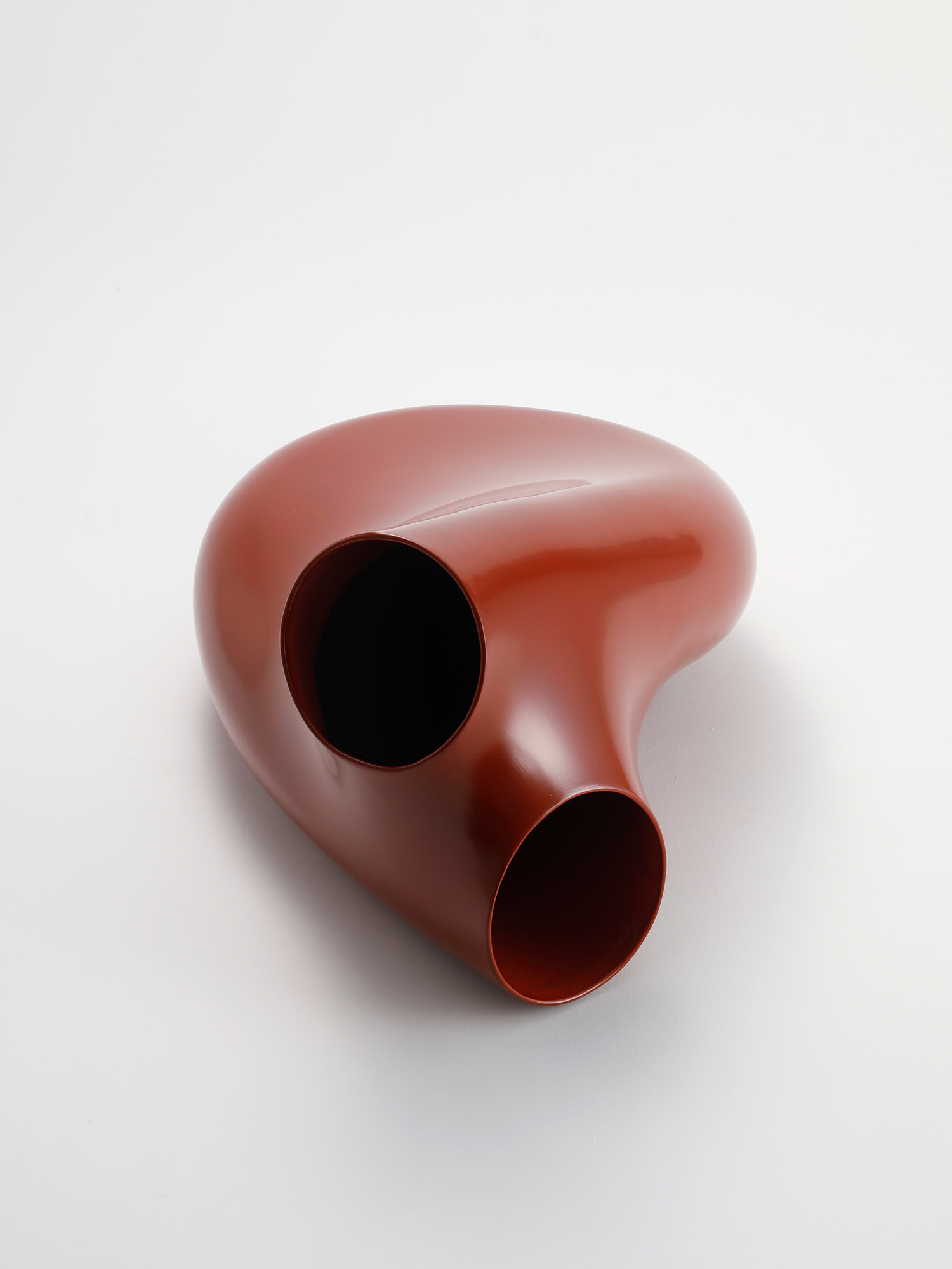 Overhead view of Absence, Presence (Awakuchi) by Genta Ishizuka, a contemporary red lacquer sculpture...