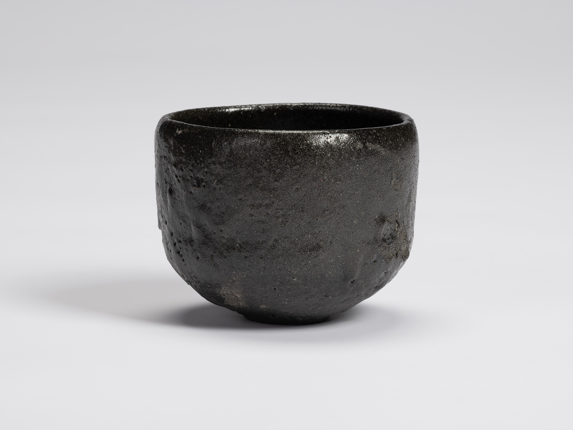 Front view of Chawan No. 10 by Shiro Tsujimura. The hand-formed tea bowl has a rounded cylindrical...
