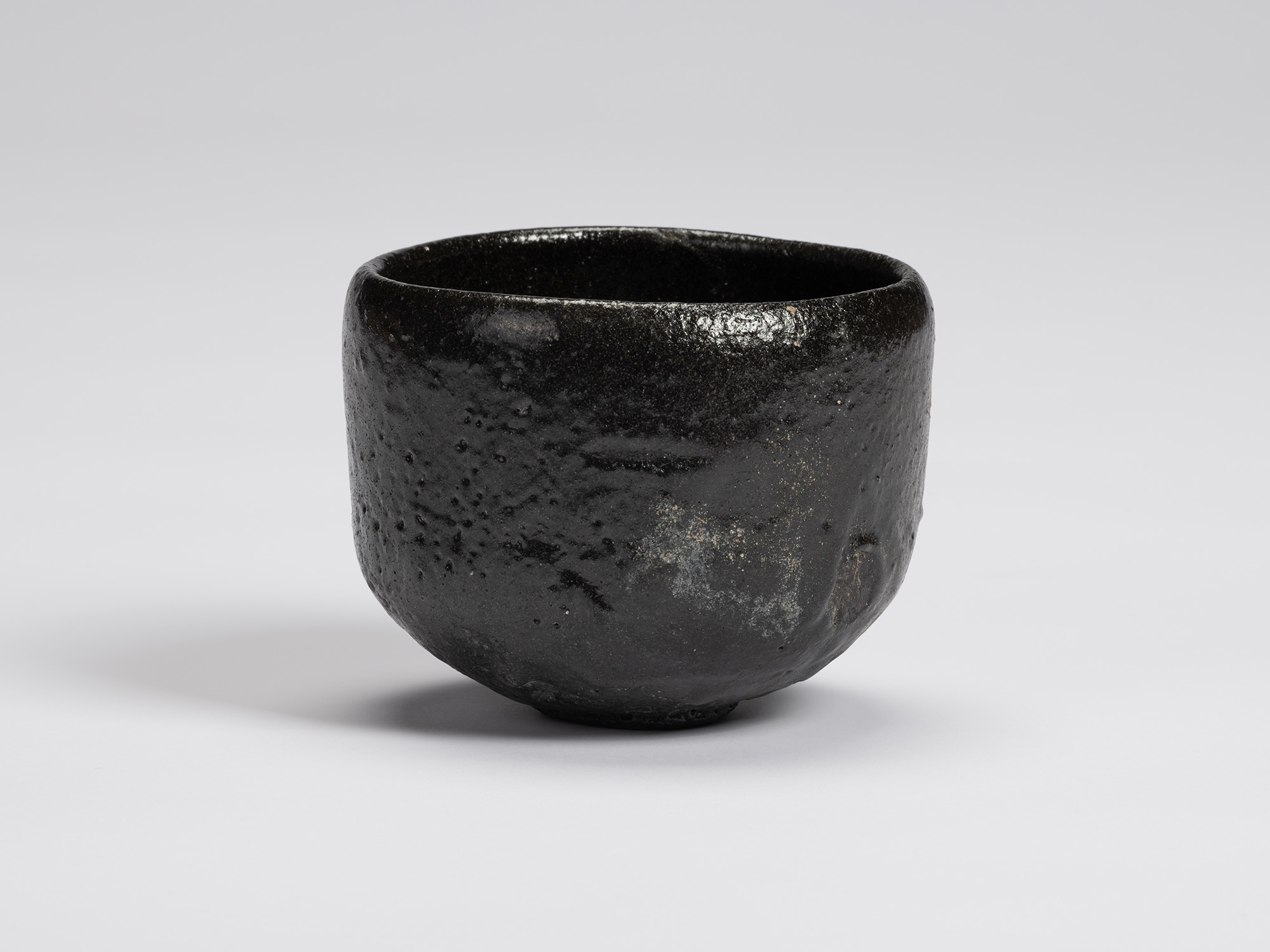 Front view of Chawan No. 10 by Shiro Tsujimura. The hand-formed tea bowl has a rounded cylindrical...