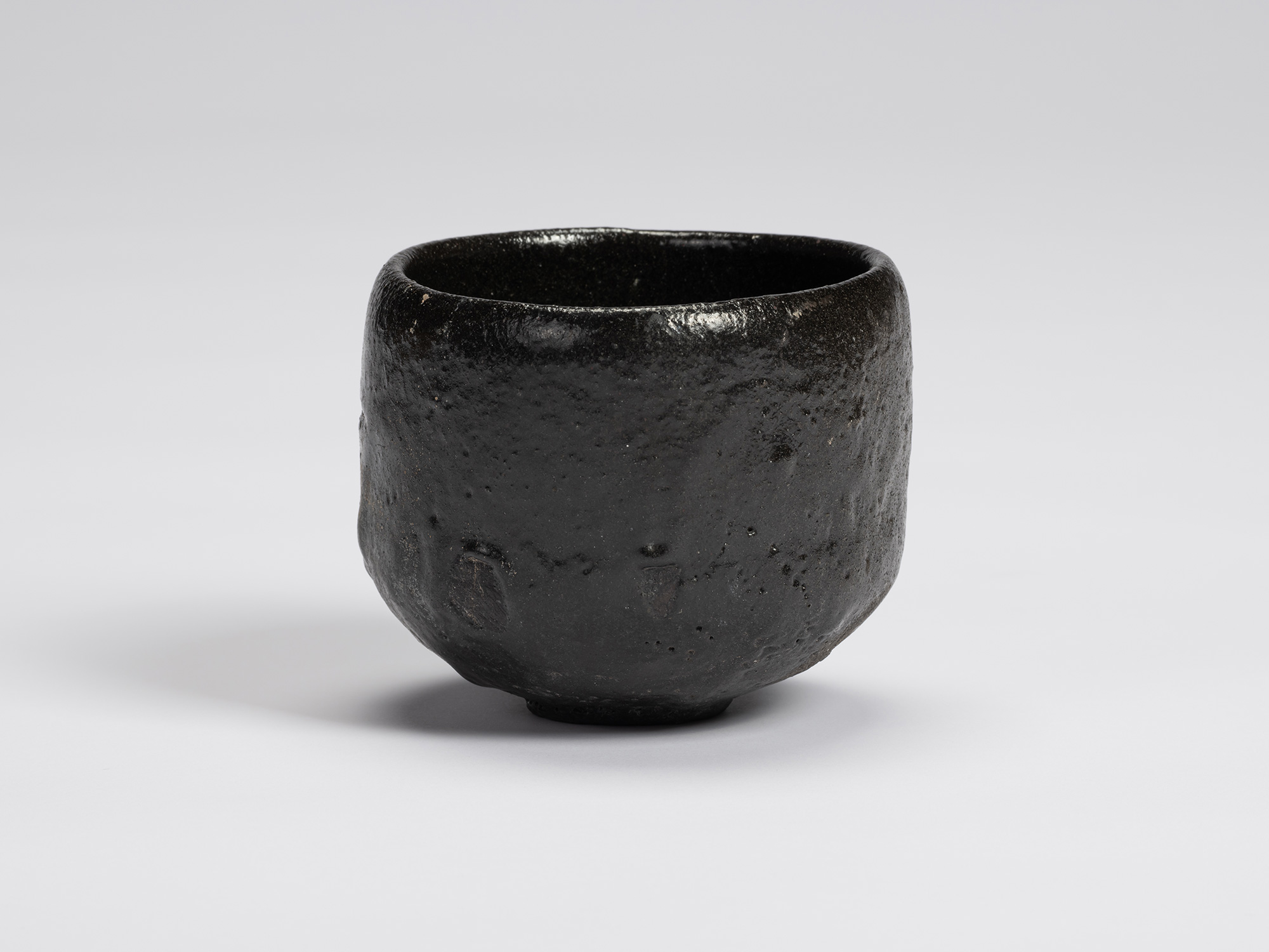 Front view of Chawan No. 10 by Shiro Tsujimura. The hand-formed tea bowl has a rounded cylindrical...