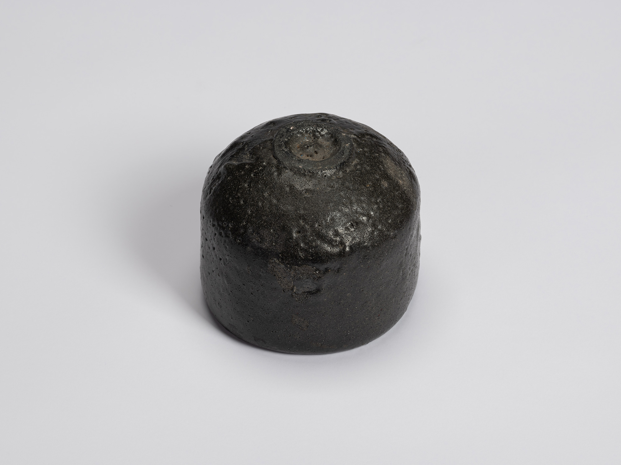 Bottom view of Chawan No. 10 showing the rounded foot with a small trimmed foot ring. The dark...