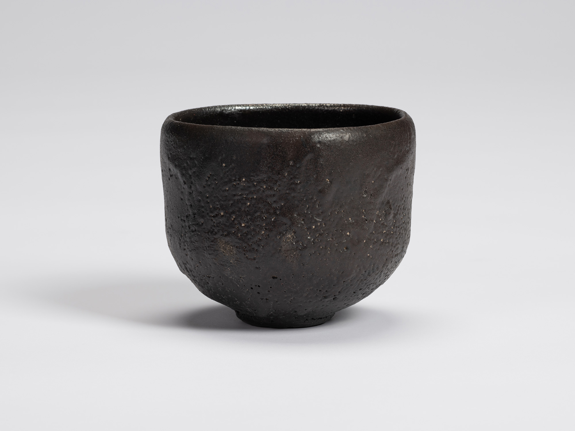Front view of Chawan No. 11 by Shiro Tsujimura. The hand-formed tea bowl has a rounded cylindrical...