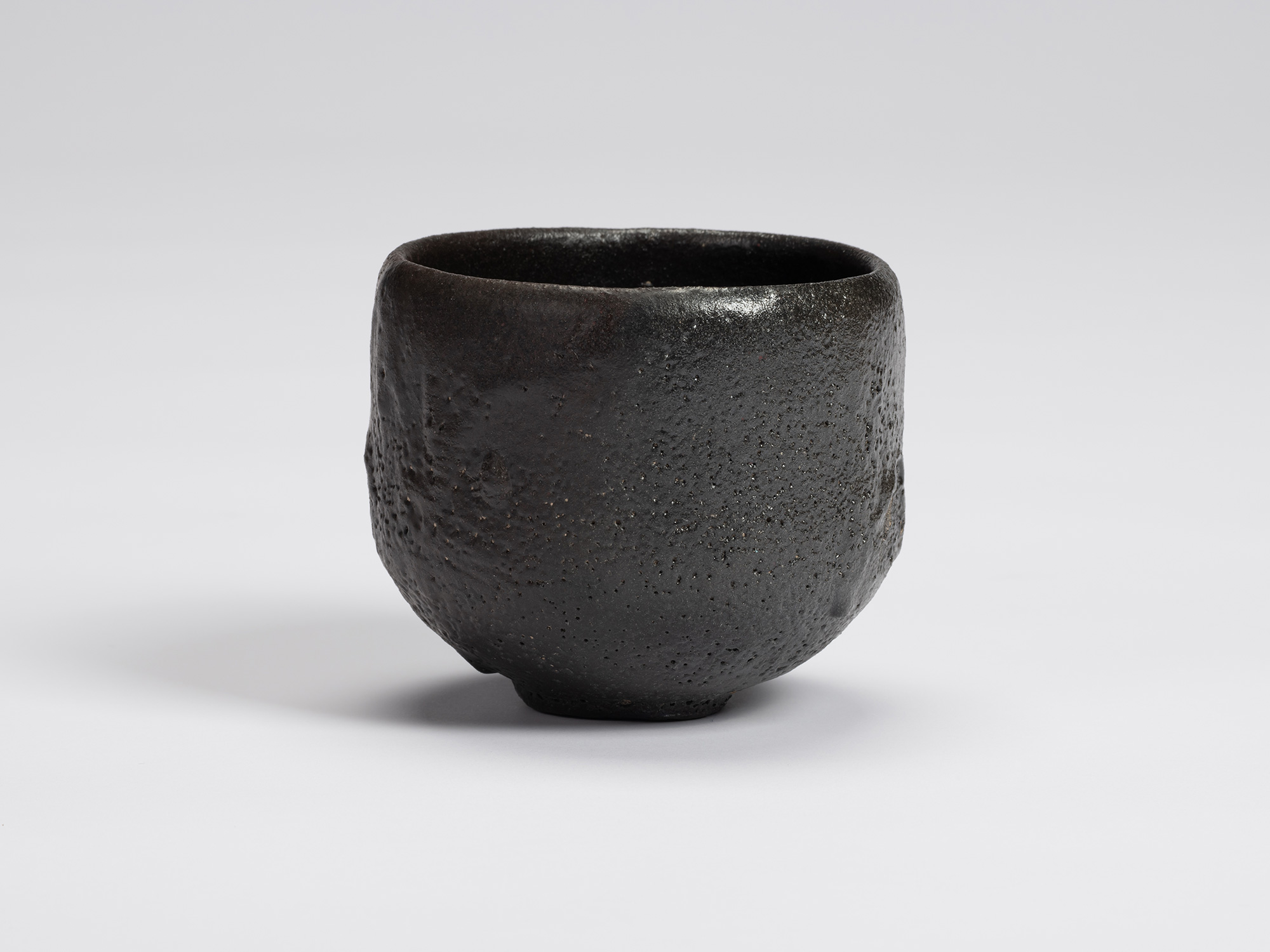 Front view of Chawan No. 11 by Shiro Tsujimura. The hand-formed tea bowl has a rounded cylindrical...