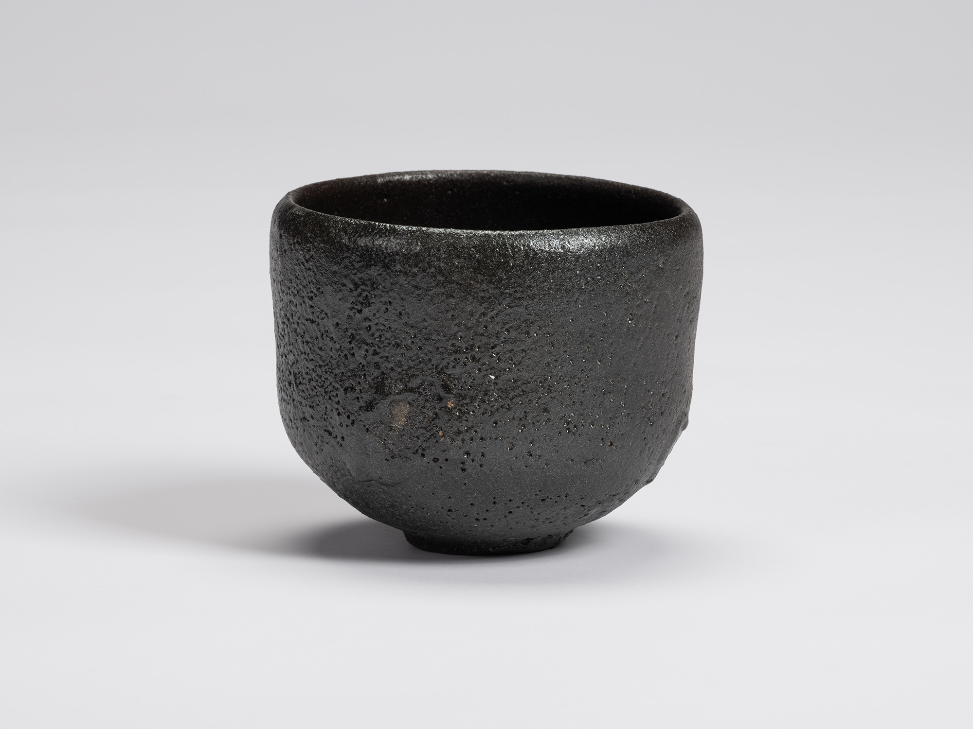 Front view of Chawan No. 11 by Shiro Tsujimura. The hand-formed tea bowl has a rounded cylindrical...