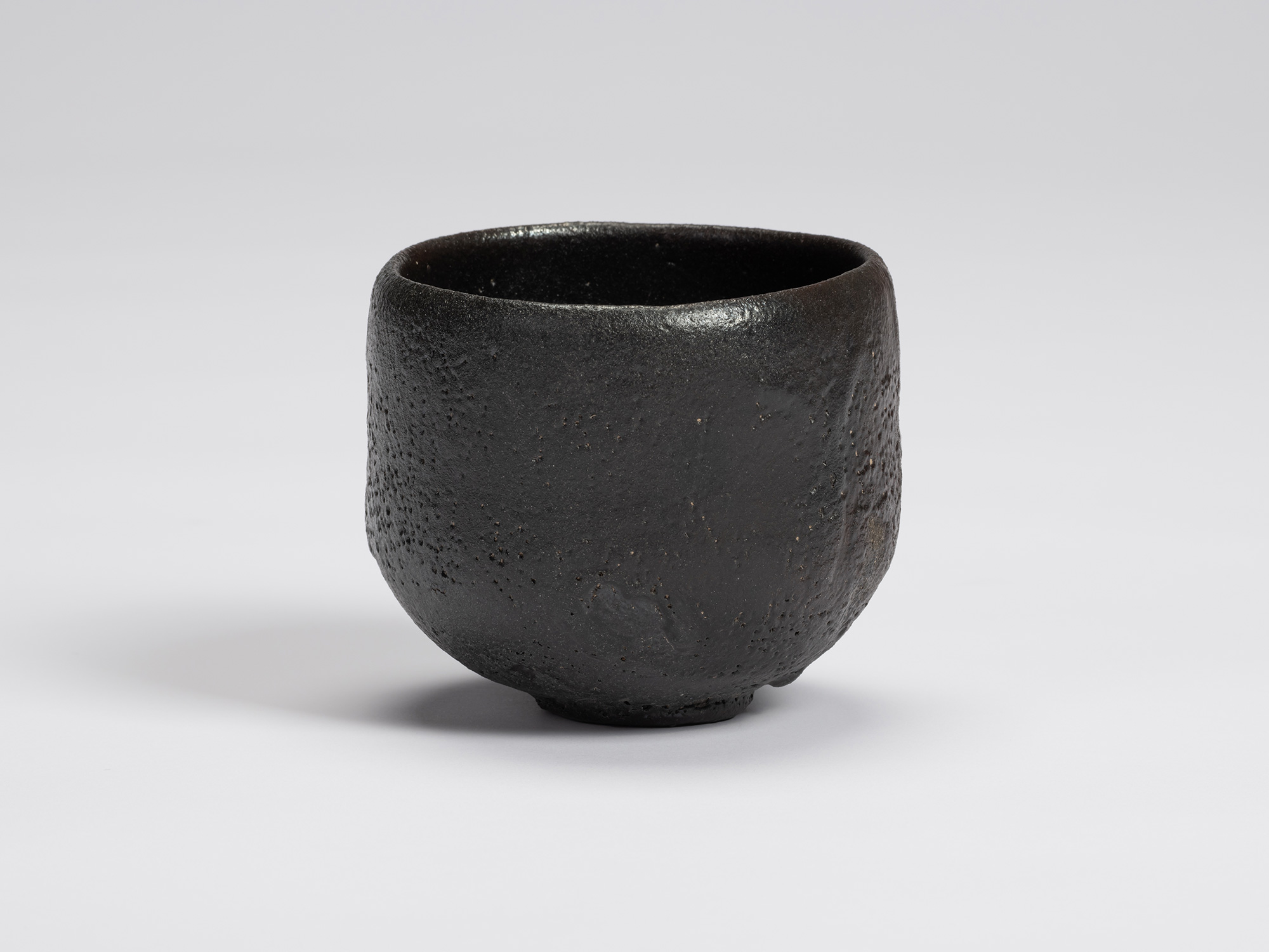 Front view of Chawan No. 11 by Shiro Tsujimura. The hand-formed tea bowl has a rounded cylindrical...