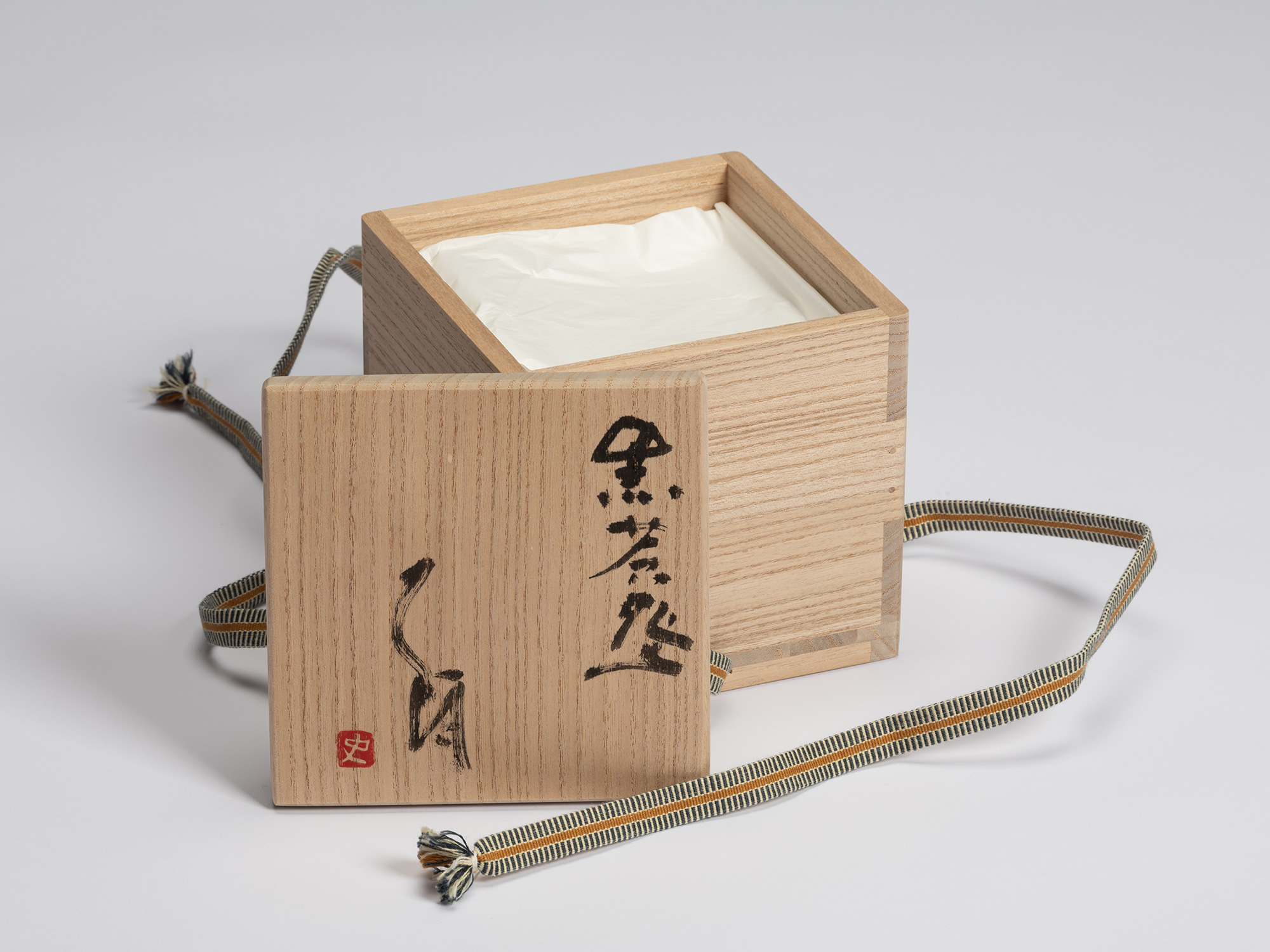 Signed wooden tomobako (presentation box) for Chawan No. 12 by Shiro Tsujimura, shown open with...