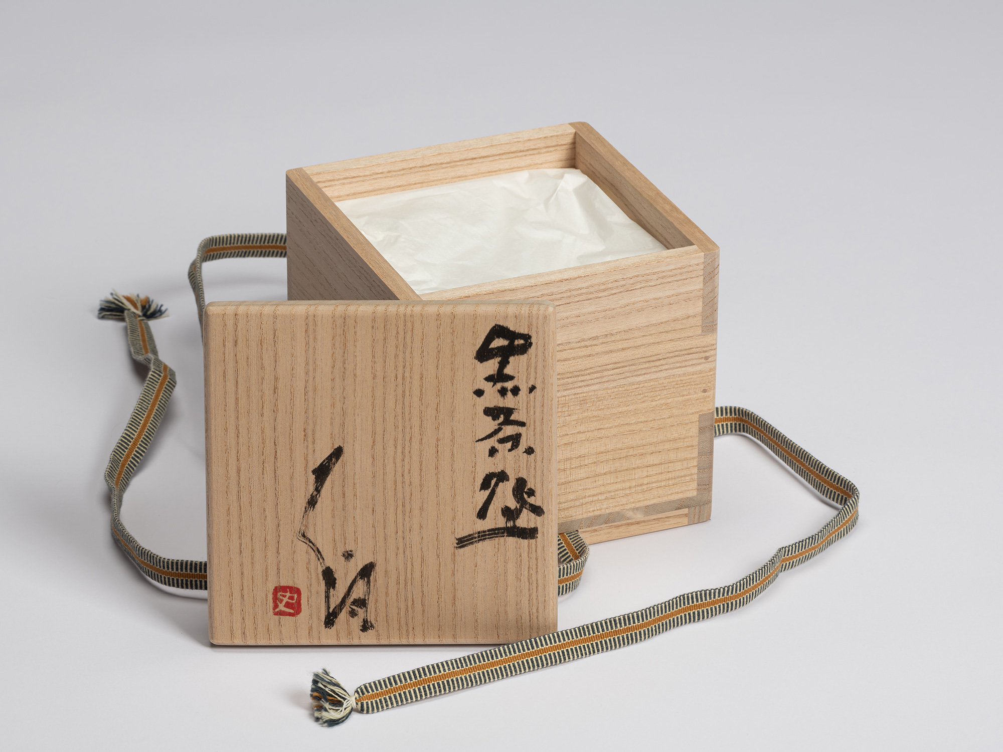 Open kiri wood tomobako for Chawan No. 13 with the lid resting beside the box. The lid is inscribed...