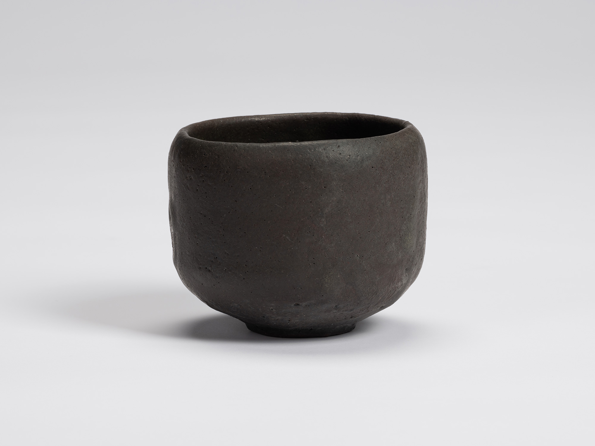 Front view of Chawan No. 14 by Shiro Tsujimura, a hand-formed black tea bowl with a gently rounded...