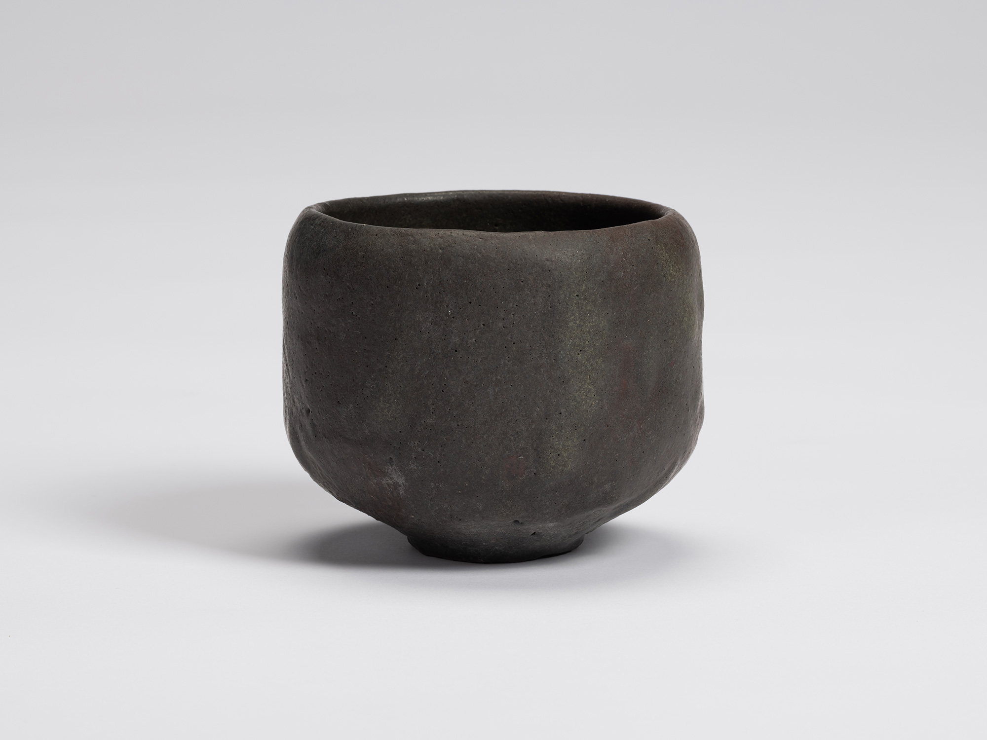 Front view of Chawan No. 14 by Shiro Tsujimura, a hand-formed black tea bowl with a gently rounded...