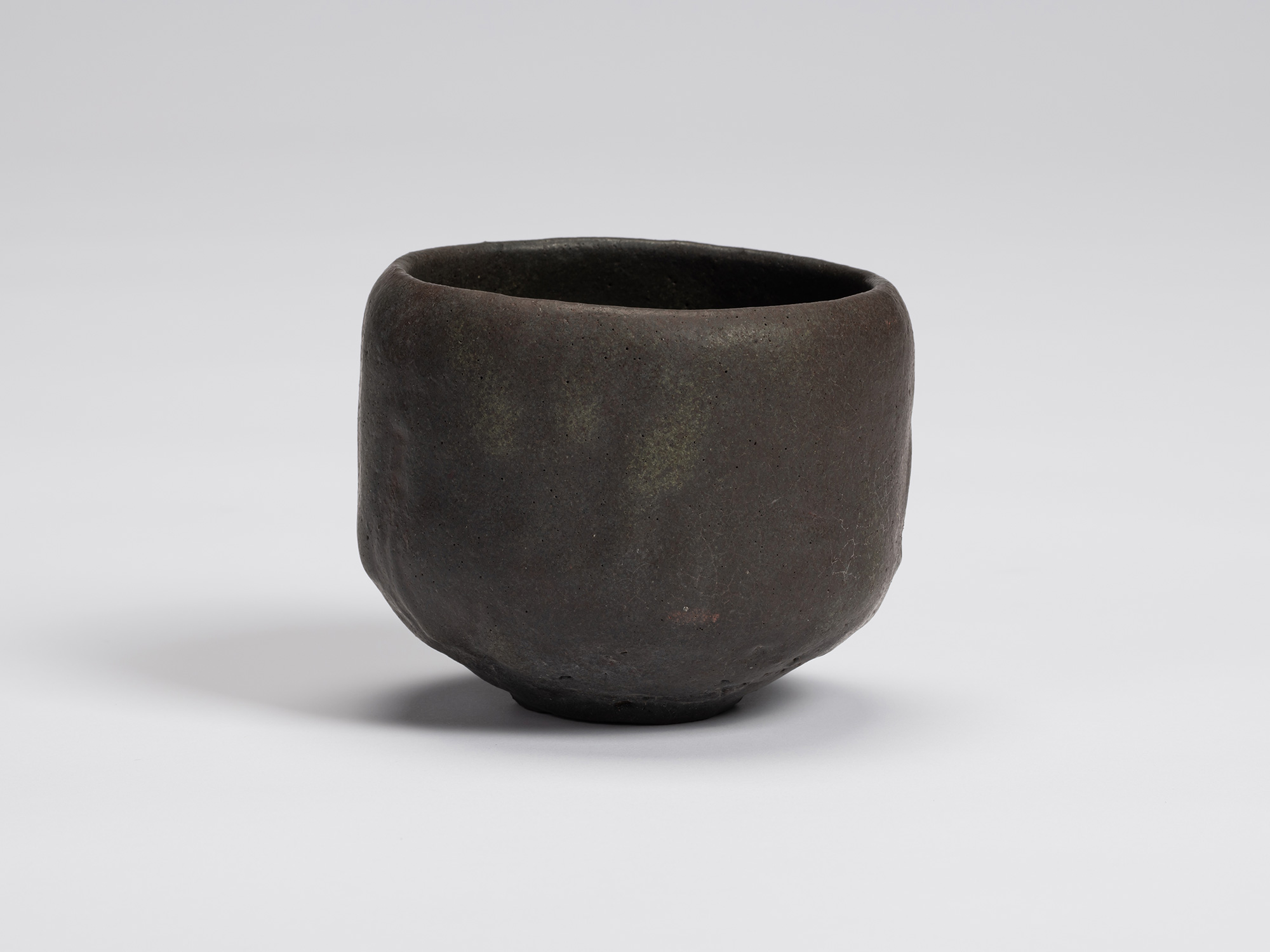 Front view of Chawan No. 14 by Shiro Tsujimura, a hand-formed black tea bowl with a gently rounded...