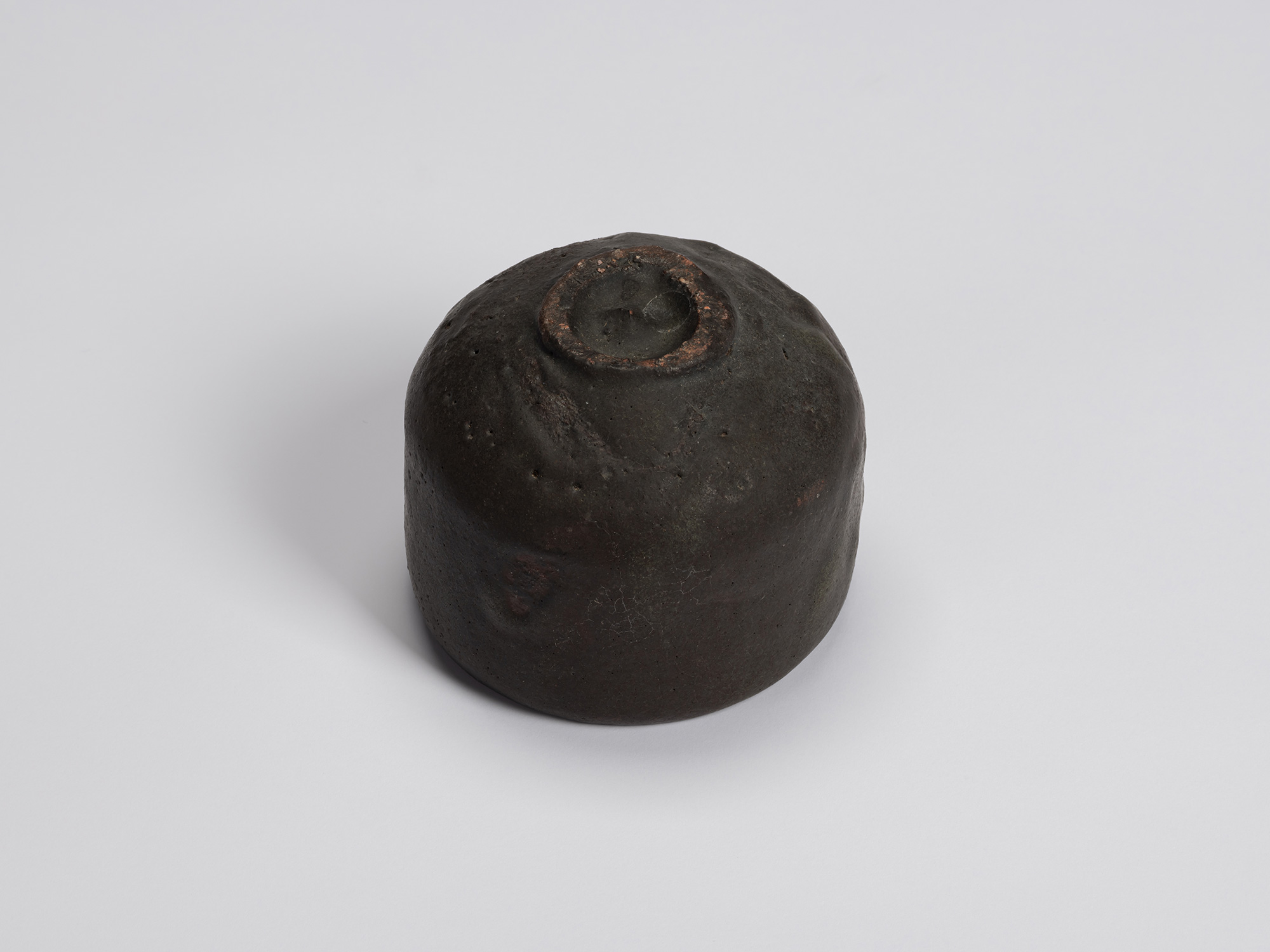 Bottom view of Chawan No. 14 revealing its compact circular foot ring with exposed reddish clay...
