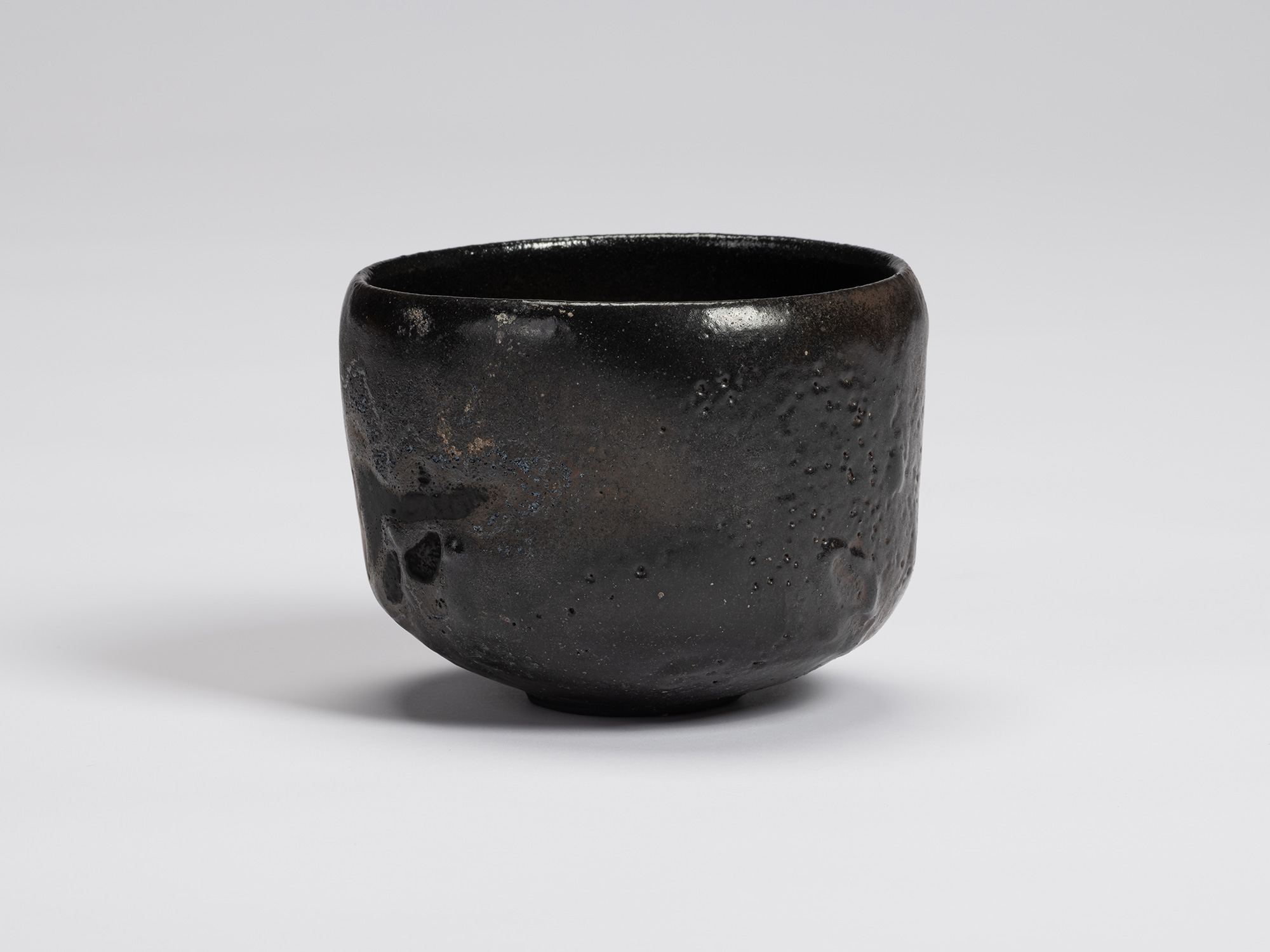 View of Chawan No. 15 by Shiro Tsujimura, a hand-formed black tea bowl with a gently rounded cylindrical...