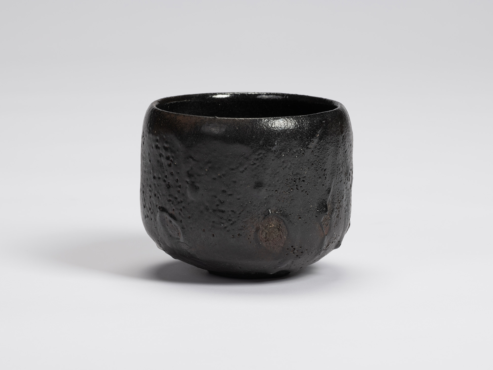 View of Chawan No. 15 by Shiro Tsujimura, a hand-formed black tea bowl with a gently rounded cylindrical...