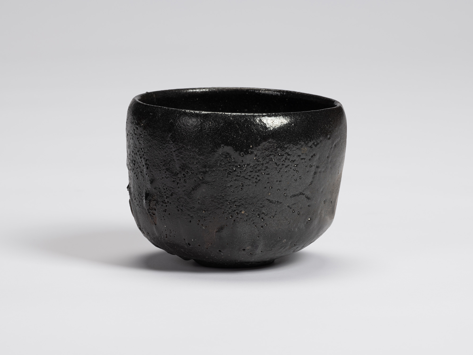 View of Chawan No. 15 by Shiro Tsujimura, a hand-formed black tea bowl with a gently rounded cylindrical...