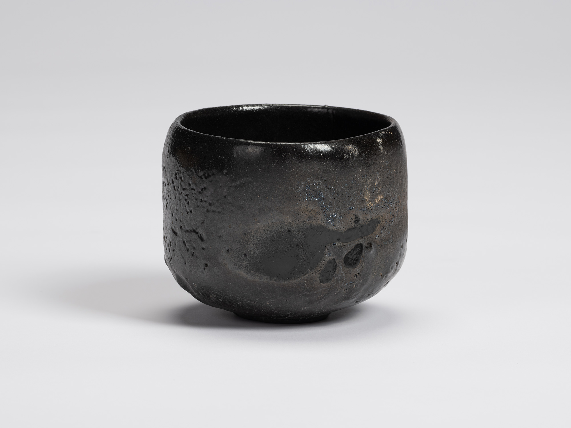 View of Chawan No. 15 by Shiro Tsujimura, a hand-formed black tea bowl with a gently rounded cylindrical...