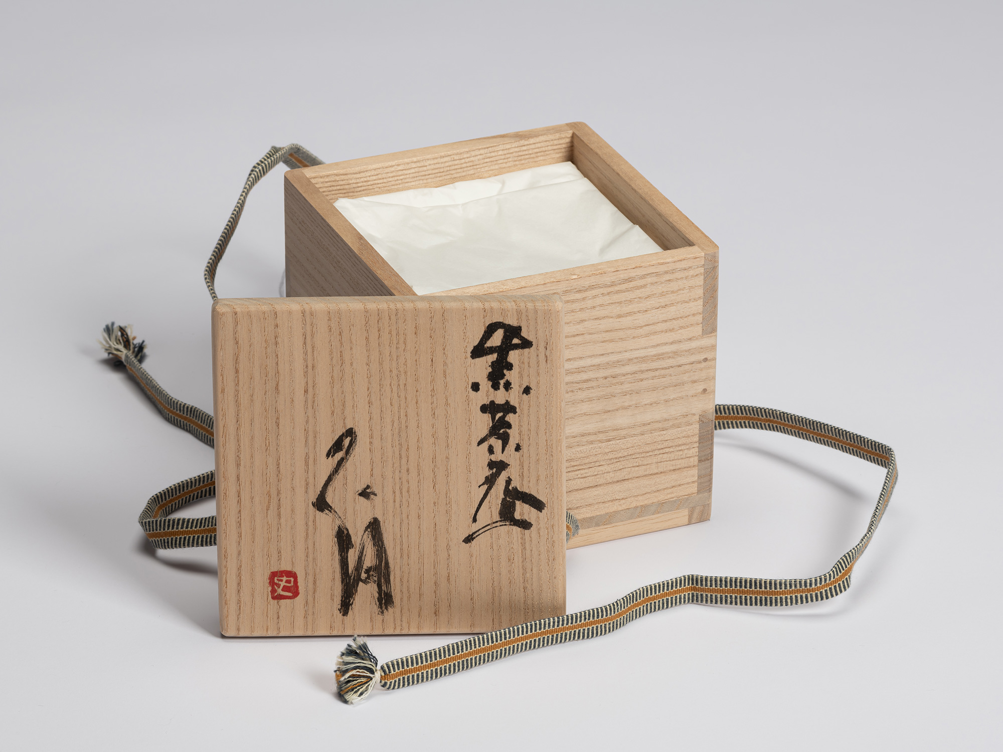 Open signed paulownia wood tomobako for Chawan No. 16 by Shiro Tsujimura. The lid is inscribed...