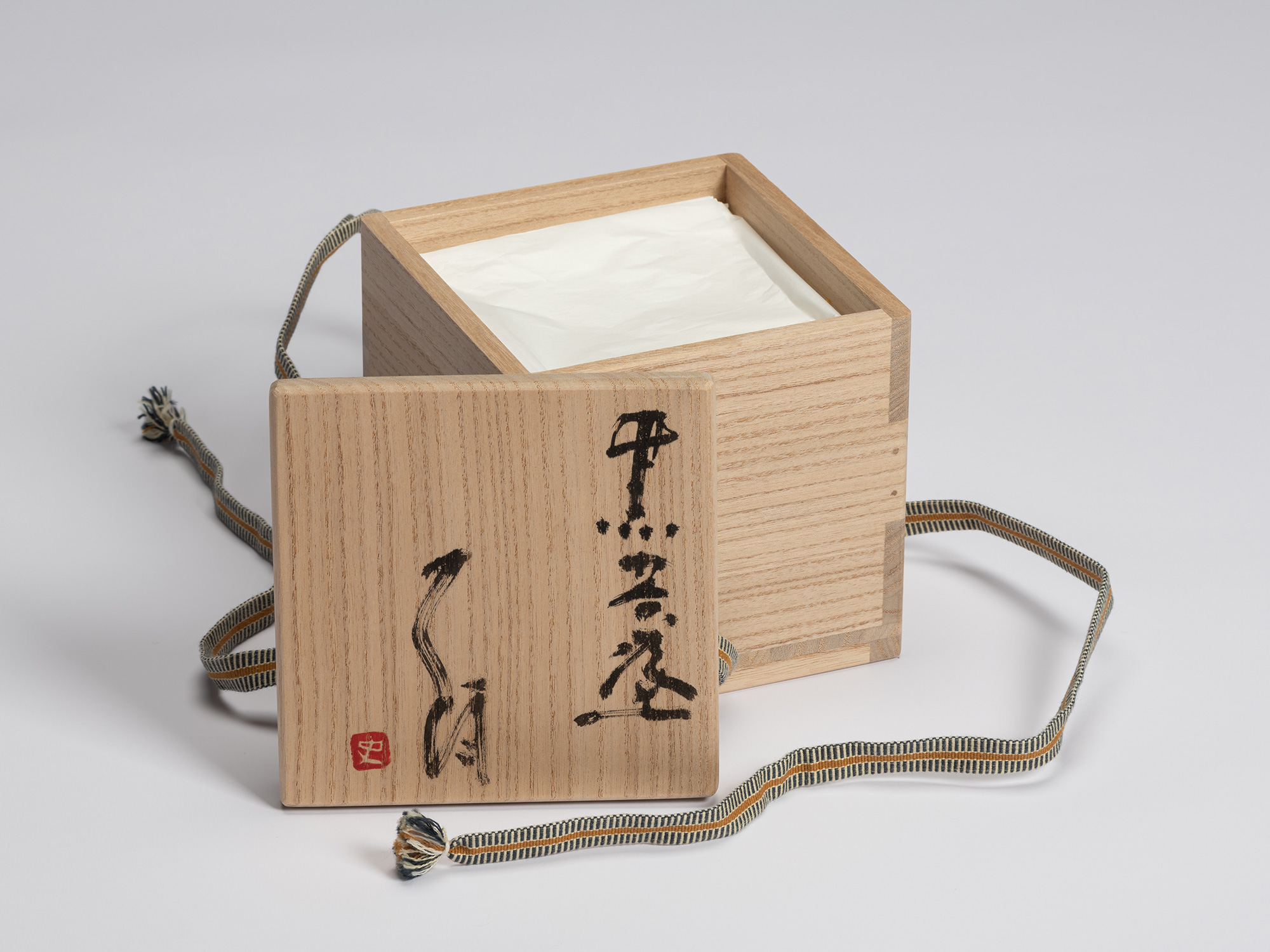 Open signed paulownia wood tomobako for Chawan No. 17 by Shiro Tsujimura. The lid is inscribed...