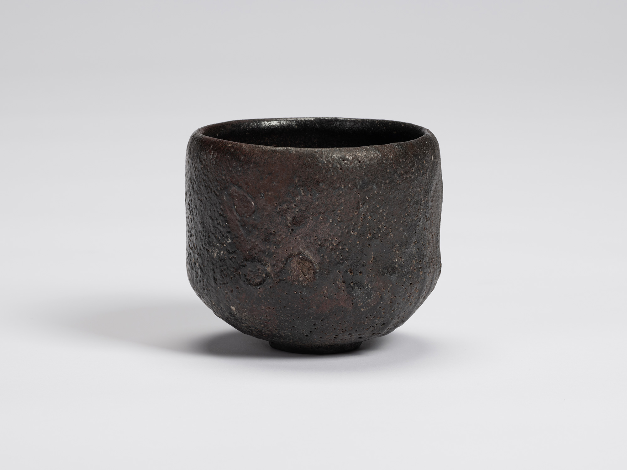 Front view of Chawan No. 17 by Shiro Tsujimura, a hand-formed black tea bowl with a gently cylindrical...
