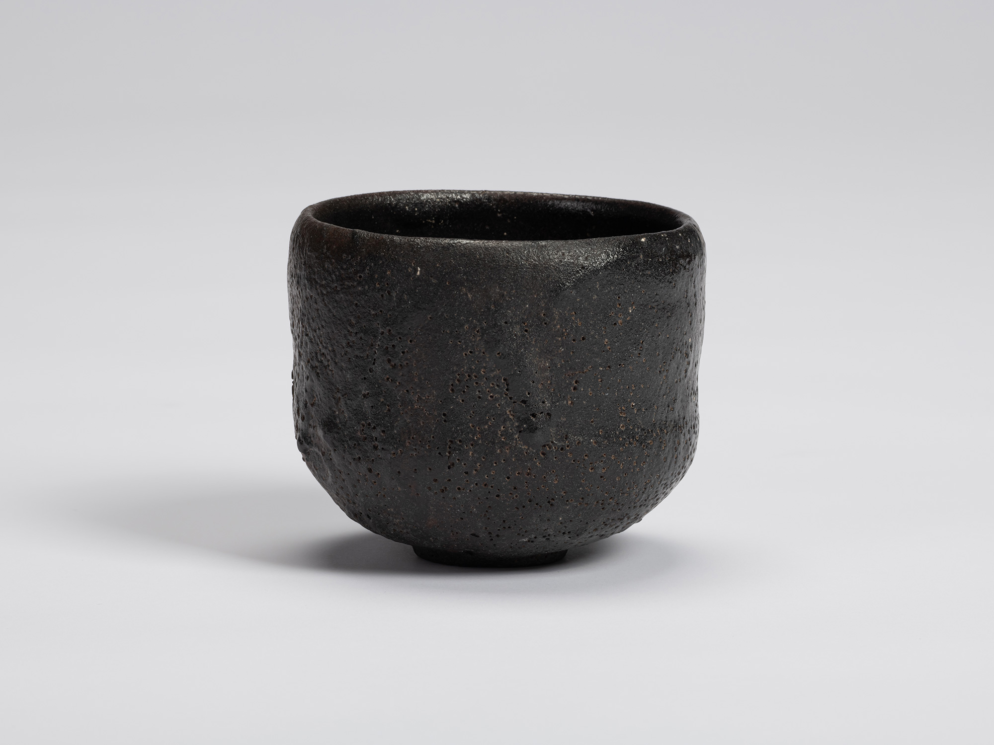 Front view of Chawan No. 17 by Shiro Tsujimura, a hand-formed black tea bowl with a gently cylindrical...