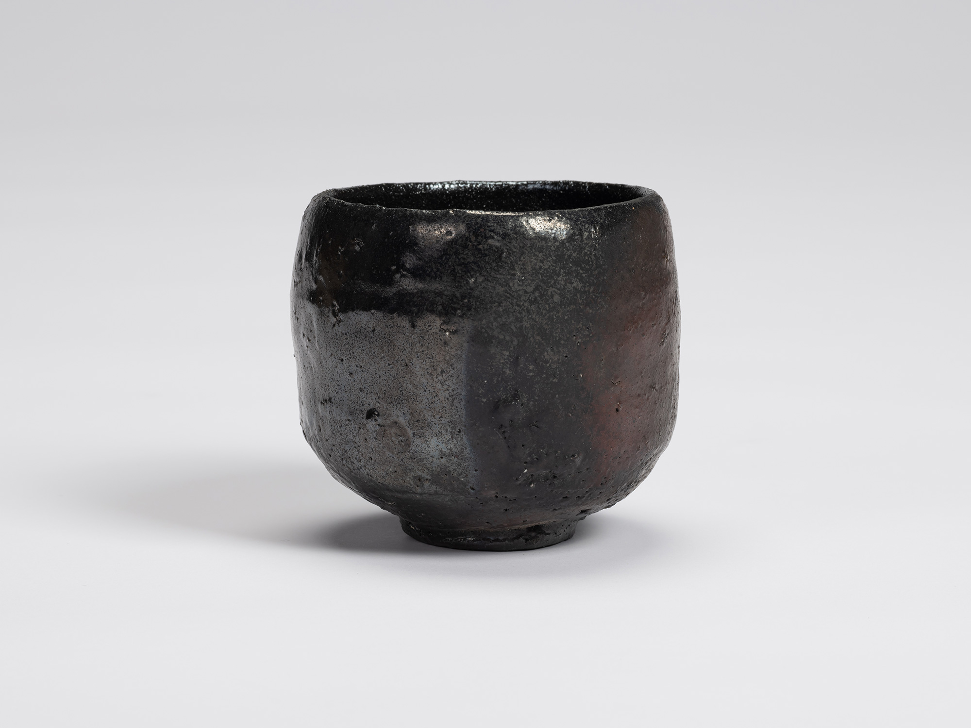 View of Kuro Chawan by Shiro Tsujimura, a hand-formed black tea bowl with softly rounded walls,...
