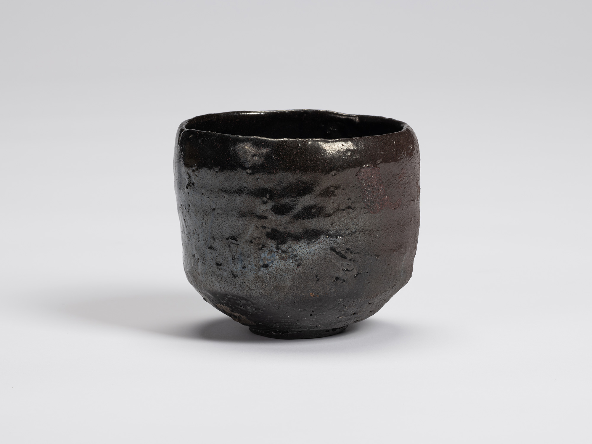 Front view of Shiro Tsujimura's Kuro Chawan, a hand-formed black tea bowl with a gently rounded...