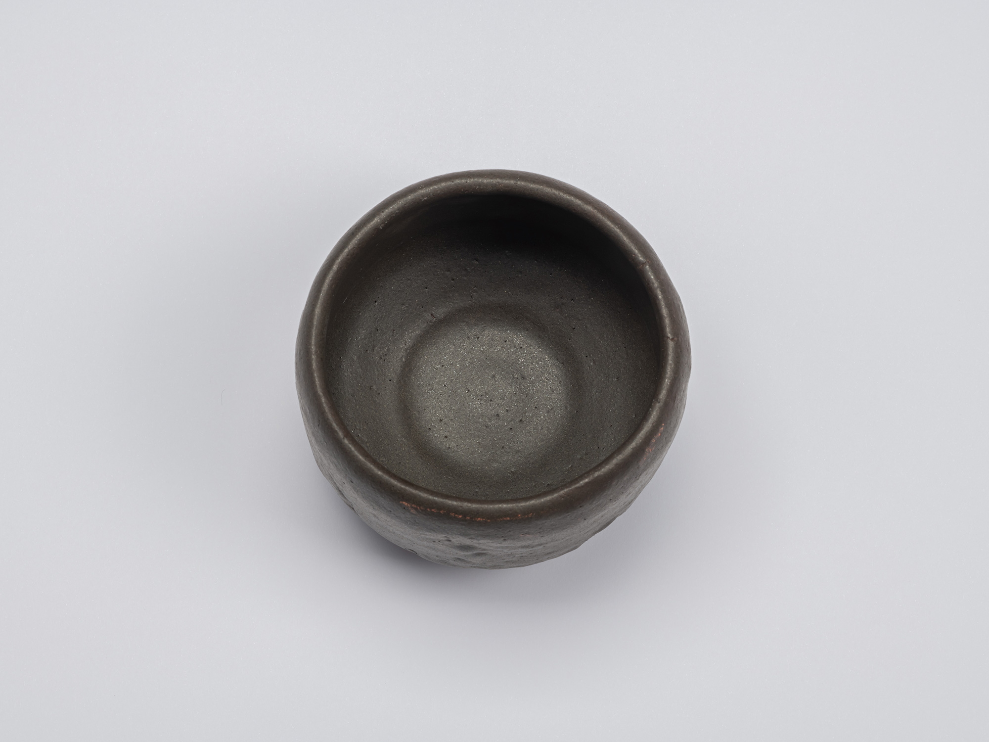 Overhead view of Kuro Chawan by Shiro Tsujimura, highlighting the softly rounded rim, deep bowl...