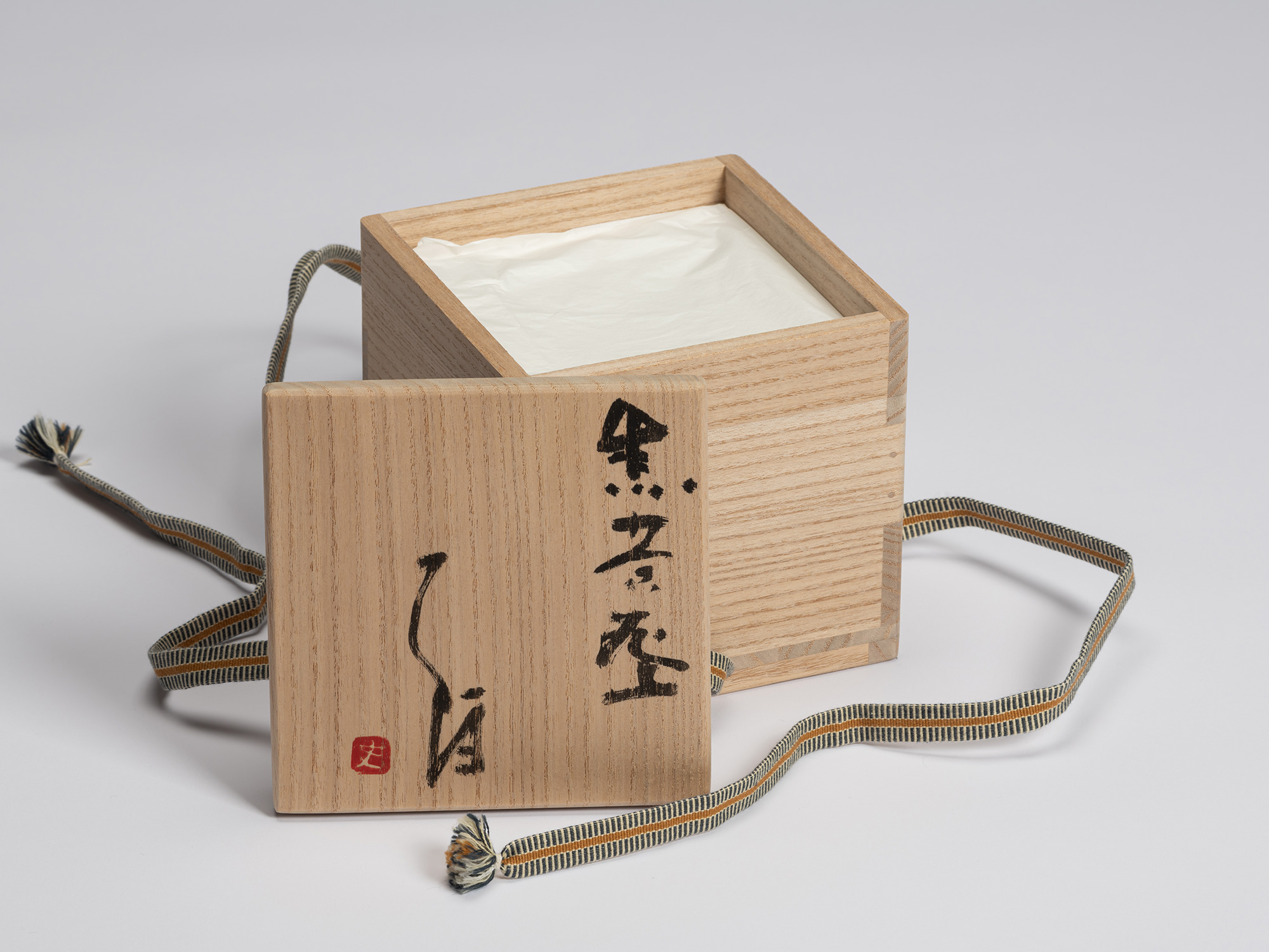 Open tomobako for Chawan No. 6 with the lid resting beside the paulownia wood box. The hand-brushed...