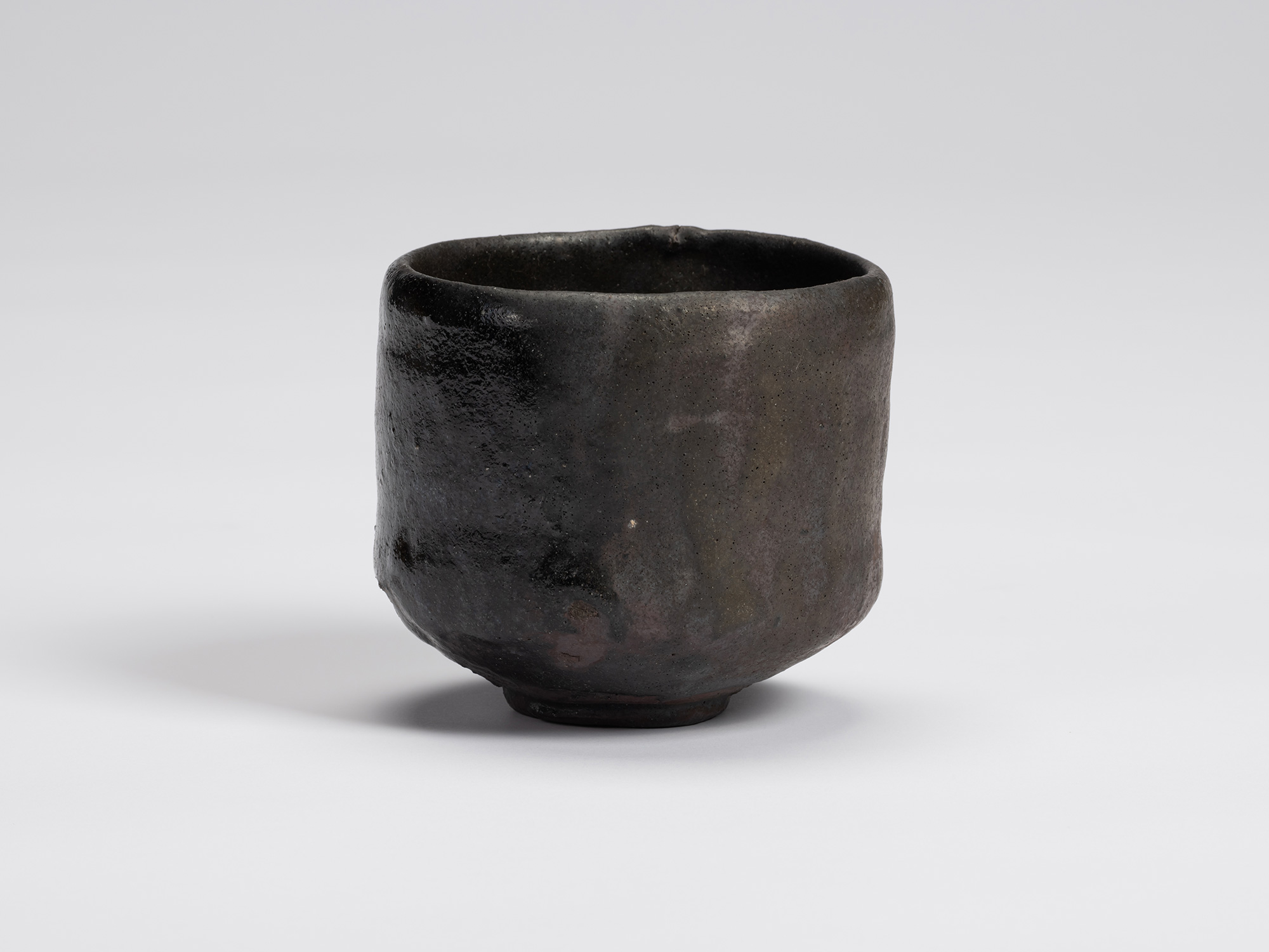 Front view of Chawan No. 6 by Shiro Tsujimura, a hand-formed black tea bowl with gently rounded...