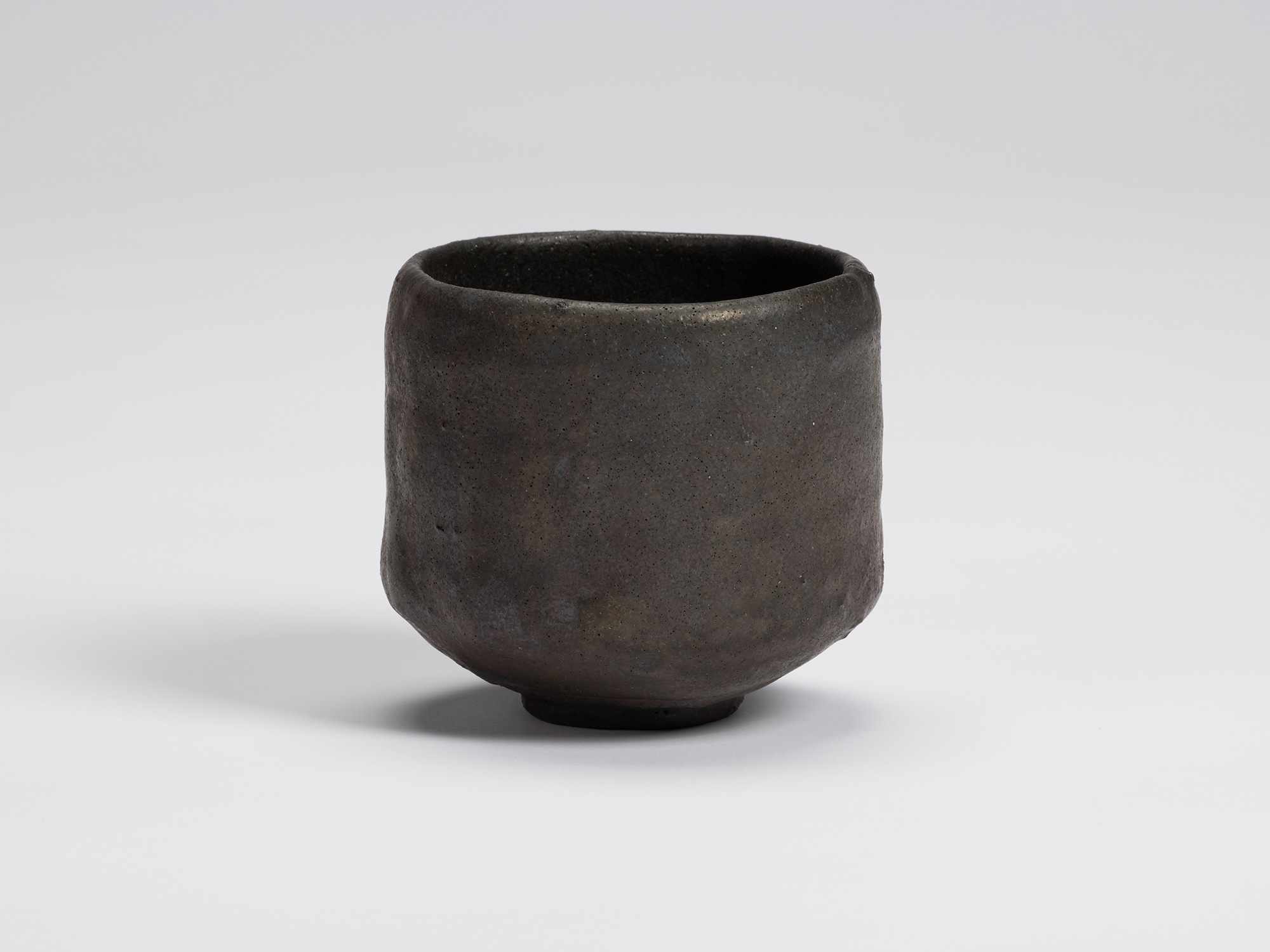 Front view of Chawan No. 6 by Shiro Tsujimura, a hand-formed black tea bowl with gently rounded...