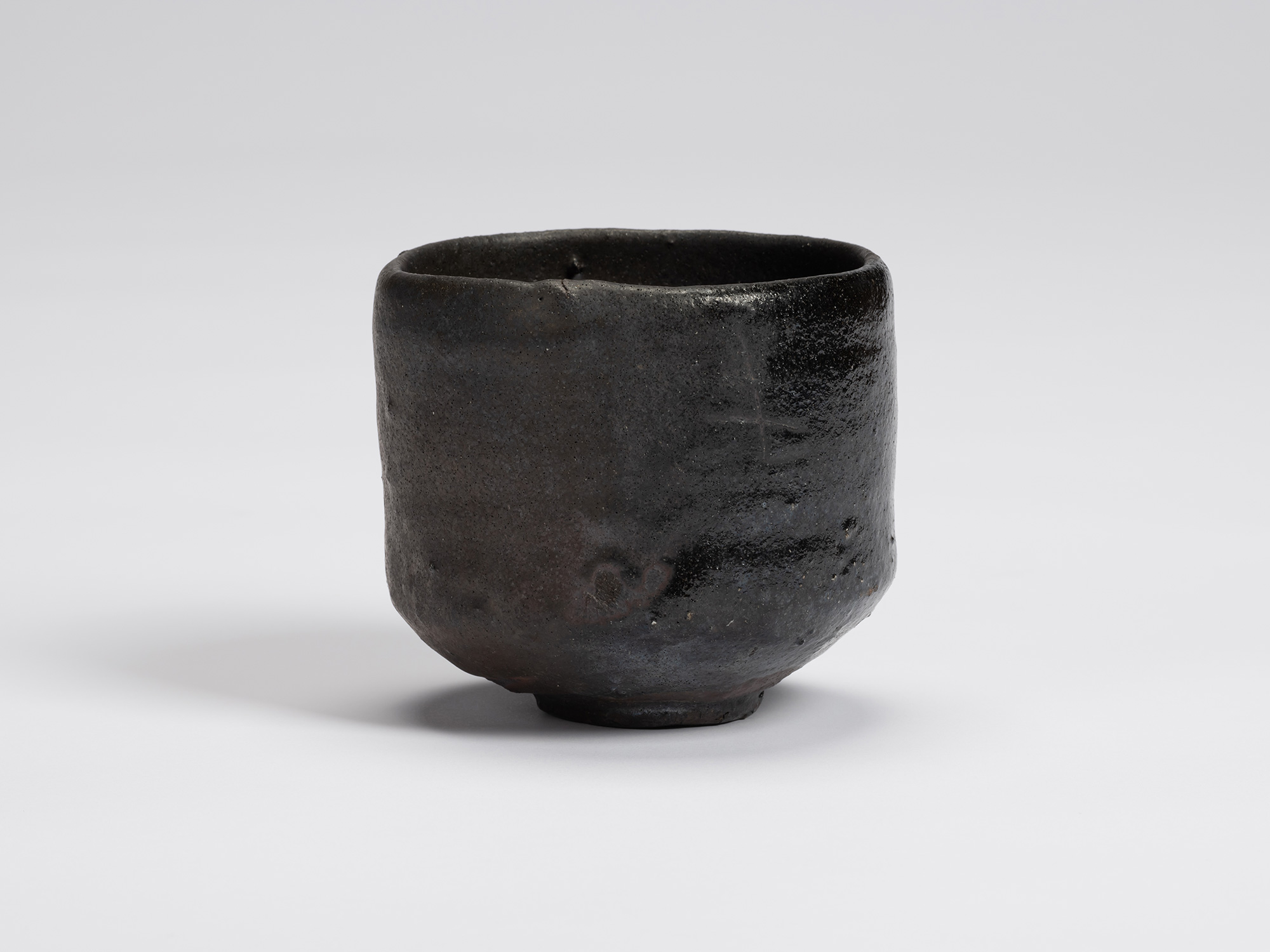 Front view of Chawan No. 6 by Shiro Tsujimura, a hand-formed black tea bowl with gently rounded...