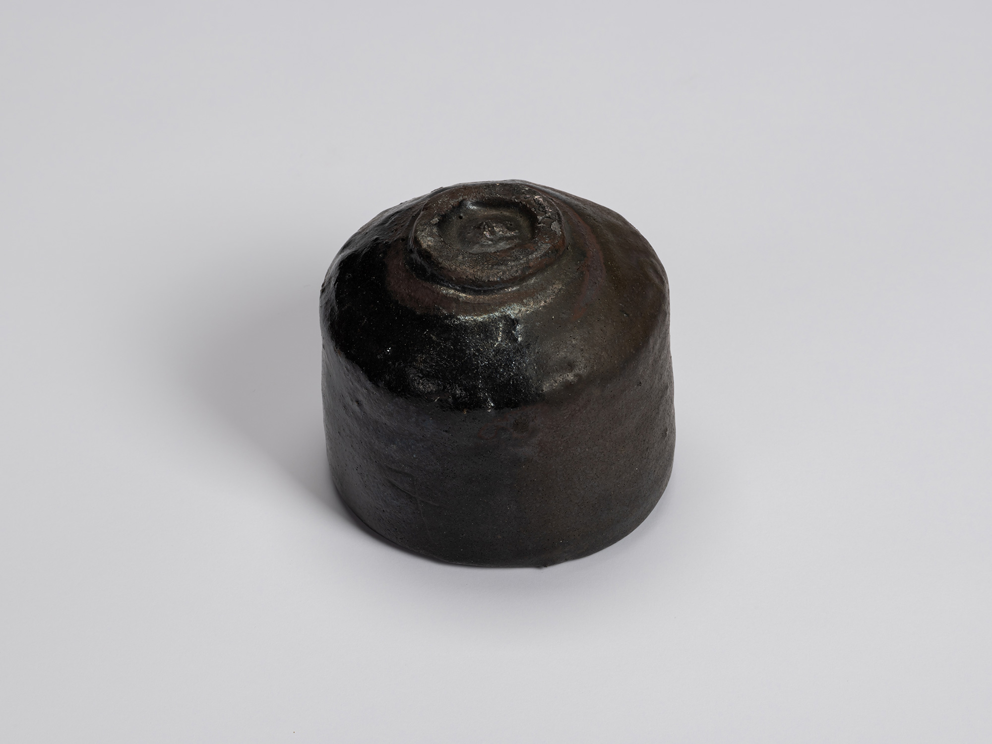 Underside of Chawan No. 6 showing its small circular foot ring and dark, carbonized surface. Variations...