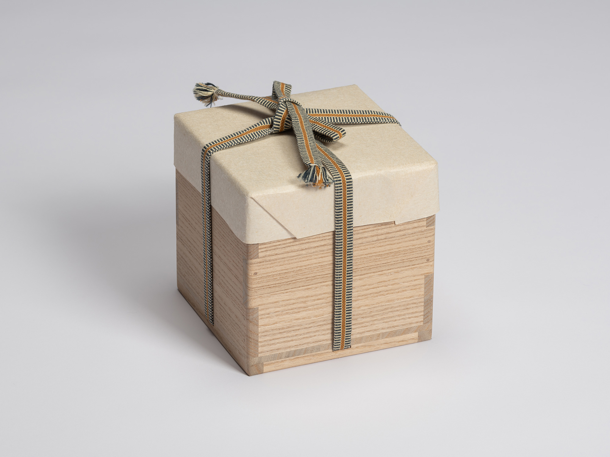 Closed paulownia wood tomobako for Chawan No. 7 by Shiro Tsujimura, wrapped in protective paper...