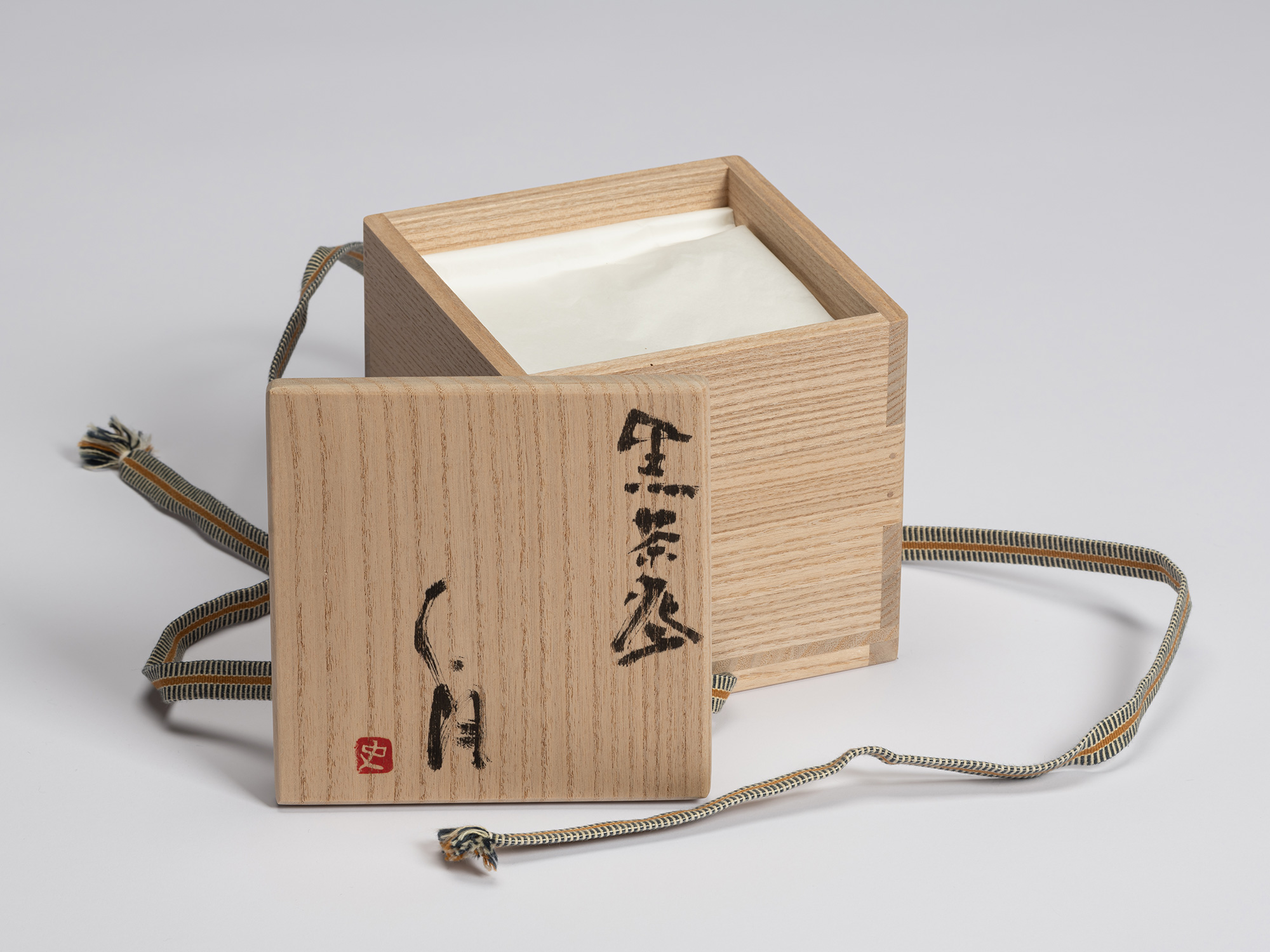 Open paulownia wood tomobako for Chawan No. 7 by Shiro Tsujimura, showing the protective cloth...