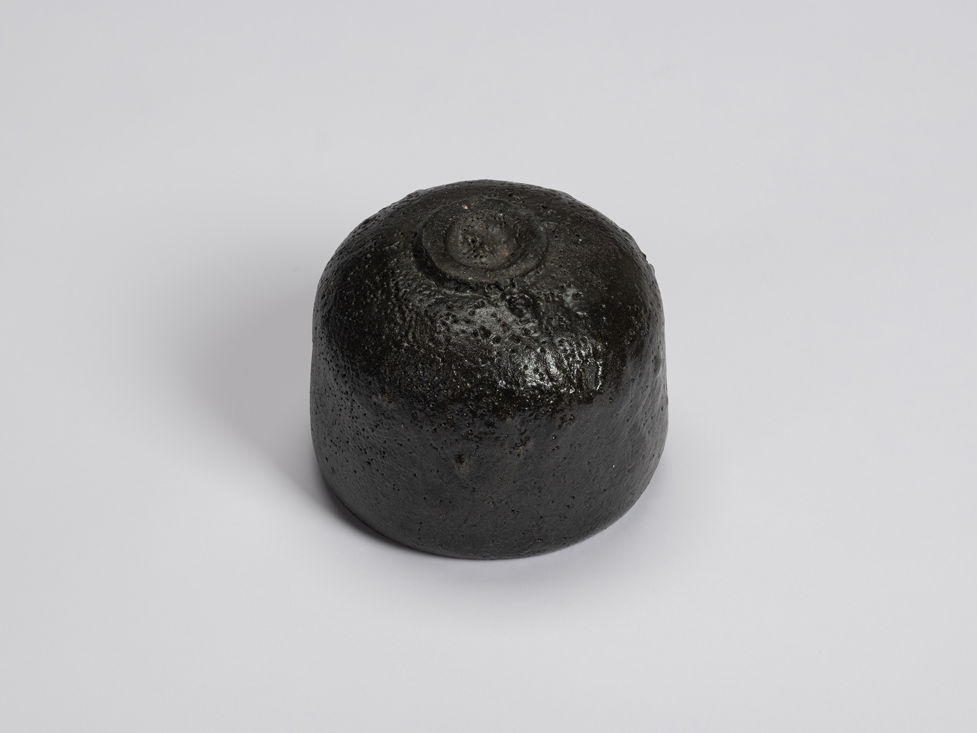 Bottom view of Chawan No. 7 showing its neatly trimmed circular foot ring surrounded by a glossy...